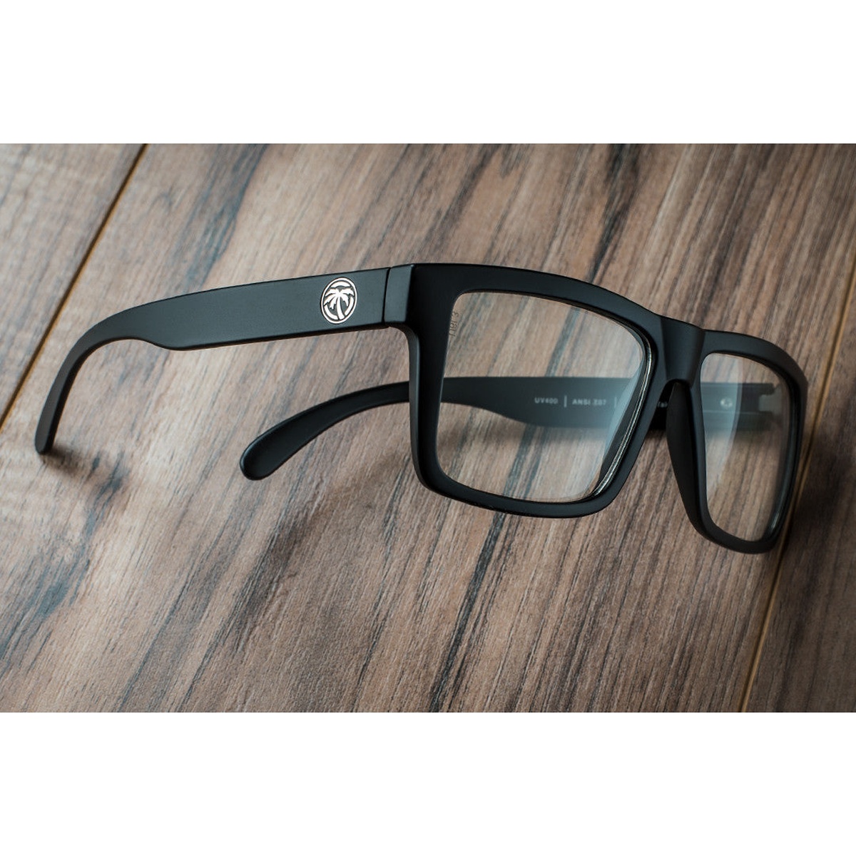 Heat Wave Visual VISE Z87 Sunglasses resting on a work surface showing black TR90 frame construction for durable everyday shop and jobsite wear