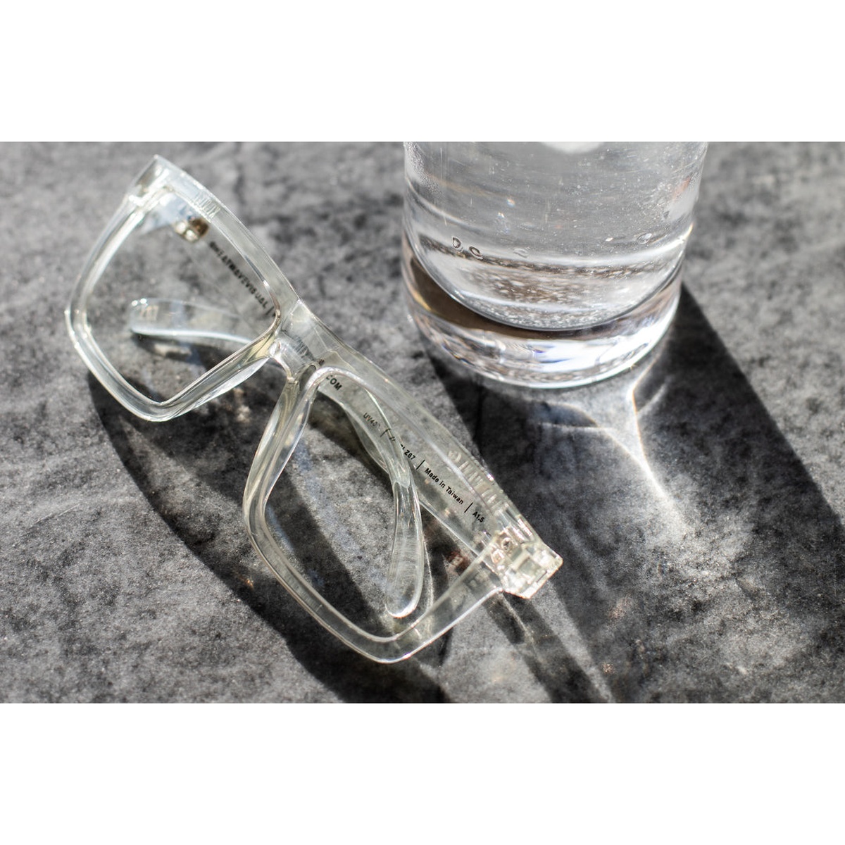 Heat Wave Visual XL VISE Z87 Sunglasses Vapor Clear Frame with clear lens resting on a work surface in bright light for everyday shop and indoor use