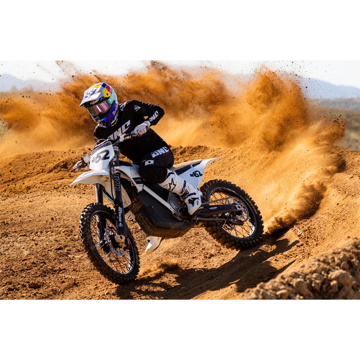 Heat Wave Visual MXG-250 Moto Goggle - Hydro Aquastone being used during motocross cornering in dusty desert terrain with a bright light lens setup