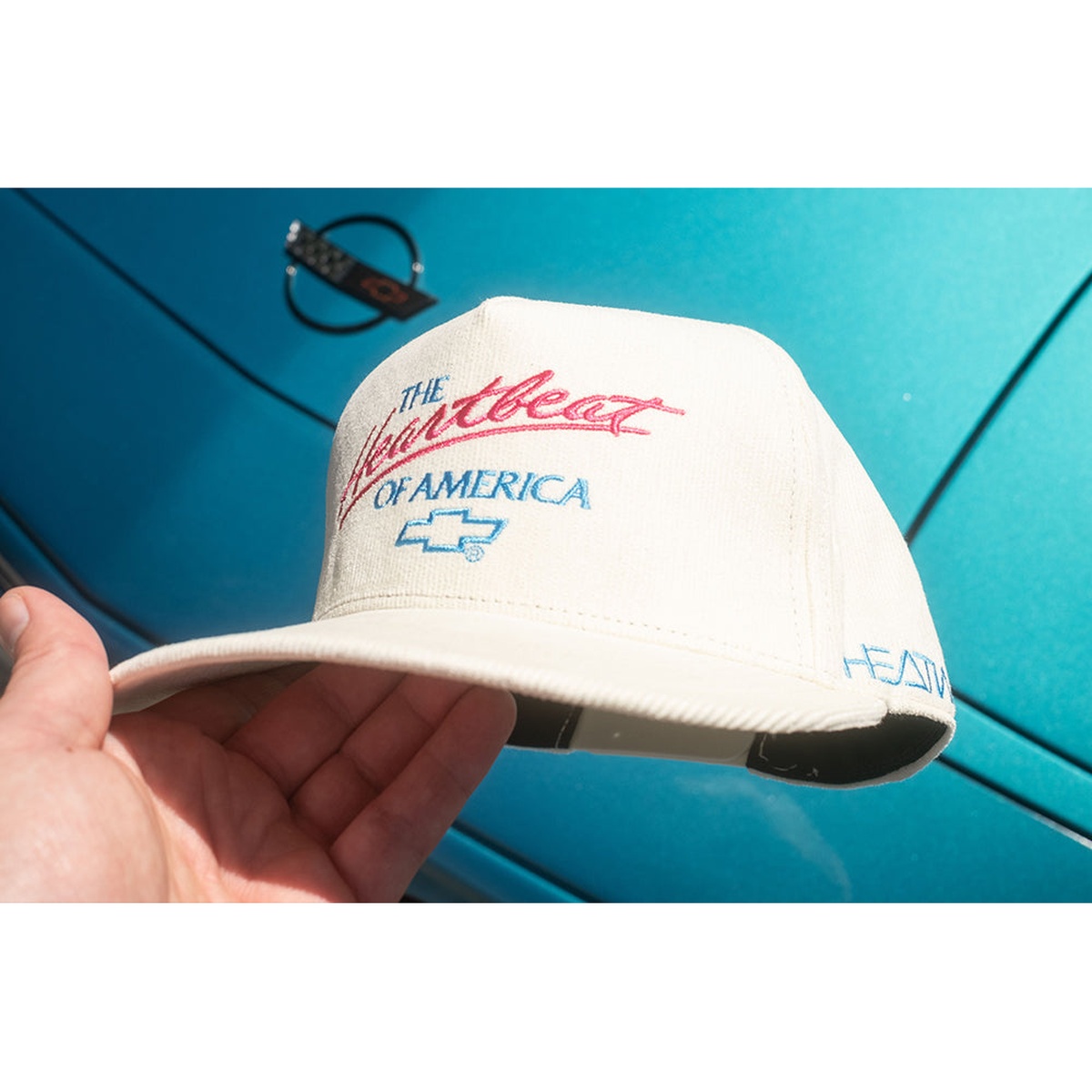 HWV Chevrolet Heartbeat of America Hat - OFF WHITE Cord with embroidered front logo and curved brim styling in an automotive setting