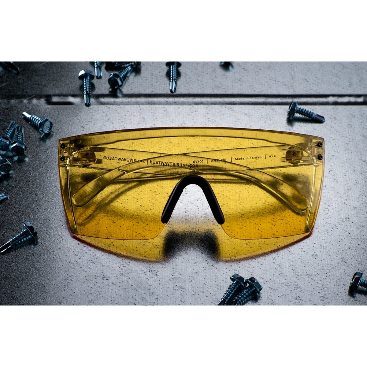 Heat Wave Visual Lazer Face Glasses: HI-VIS YELLOW Z87 showing full shield lens, wrapped arms, and hardware in a workshop environment