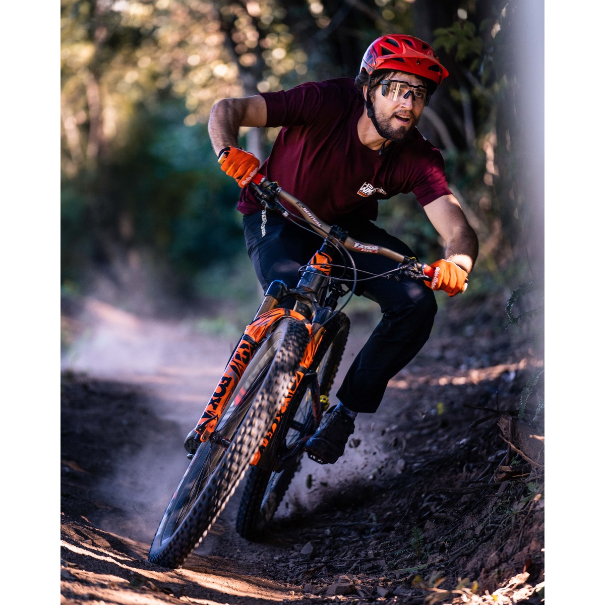 Heat Wave Visual Future Tech Sunglasses: Black Frame Clear Lens Z87+ worn during aggressive mountain bike riding on a dirt trail for high-speed eye protection