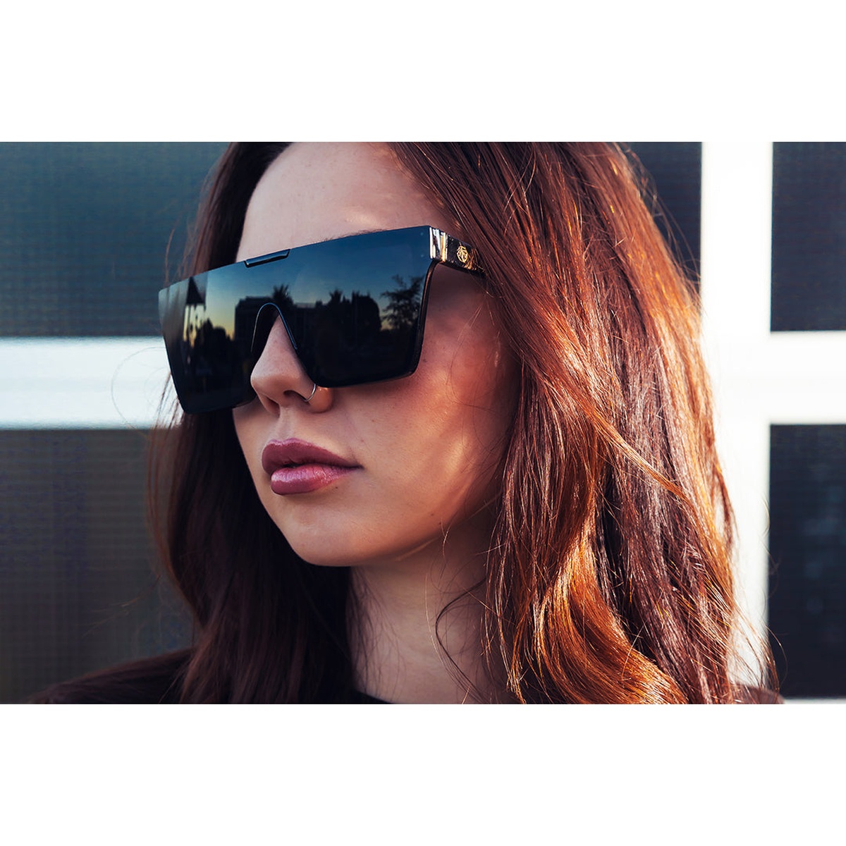 Heat Wave Visual Clarity Sunglasses: Ultra Black worn outdoors in strong sunlight for high-glare daytime use