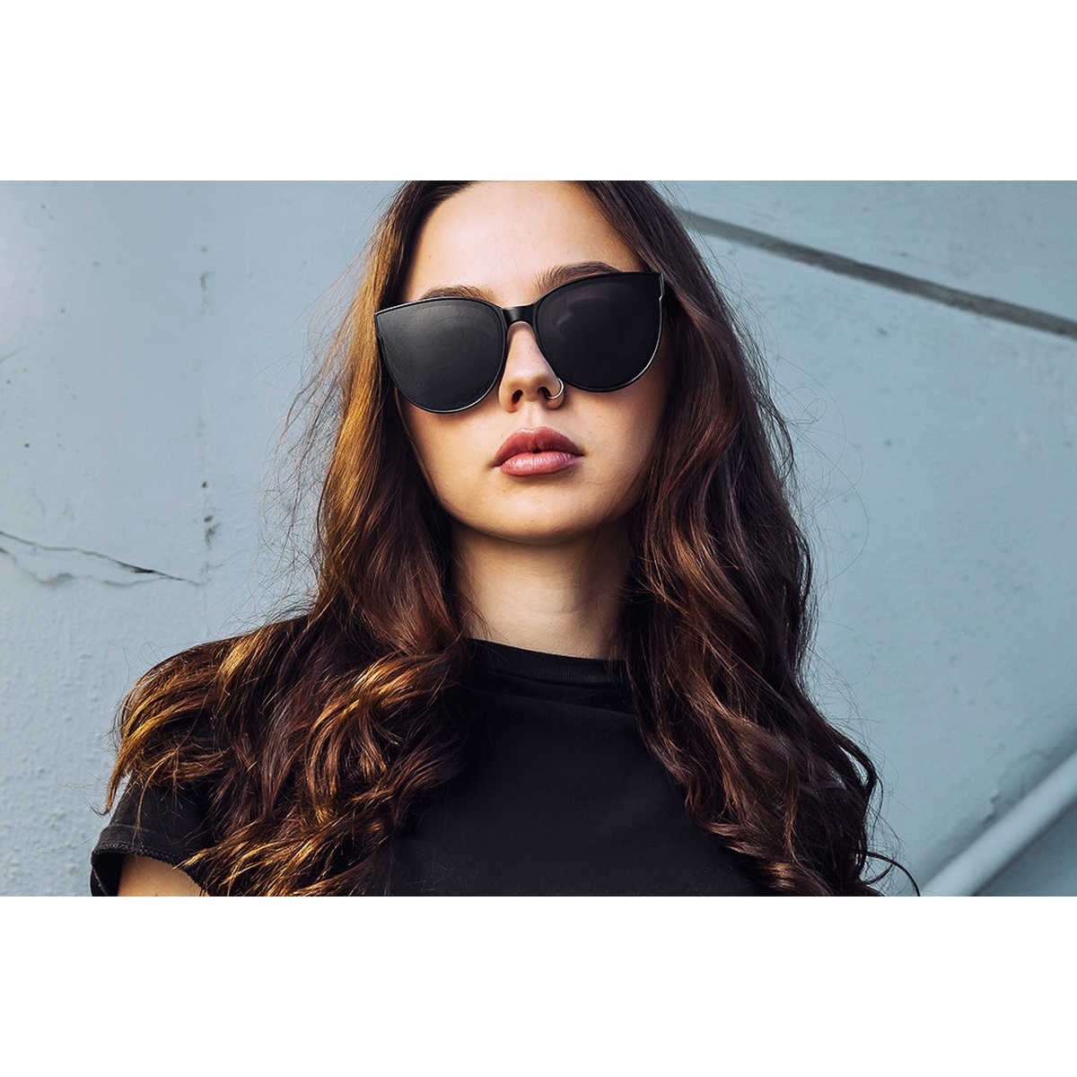 Heat Wave Visual Carat Sunglasses: Ultra Black worn outdoors in bright daylight for everyday fashion and high-glare sun protection