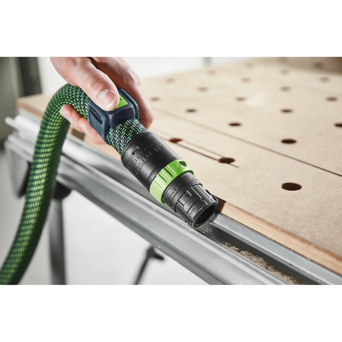 Festool 578499 Bluetooth Remote Control mounted on a Festool suction hose for starting a CT dust extractor during bench cleanup