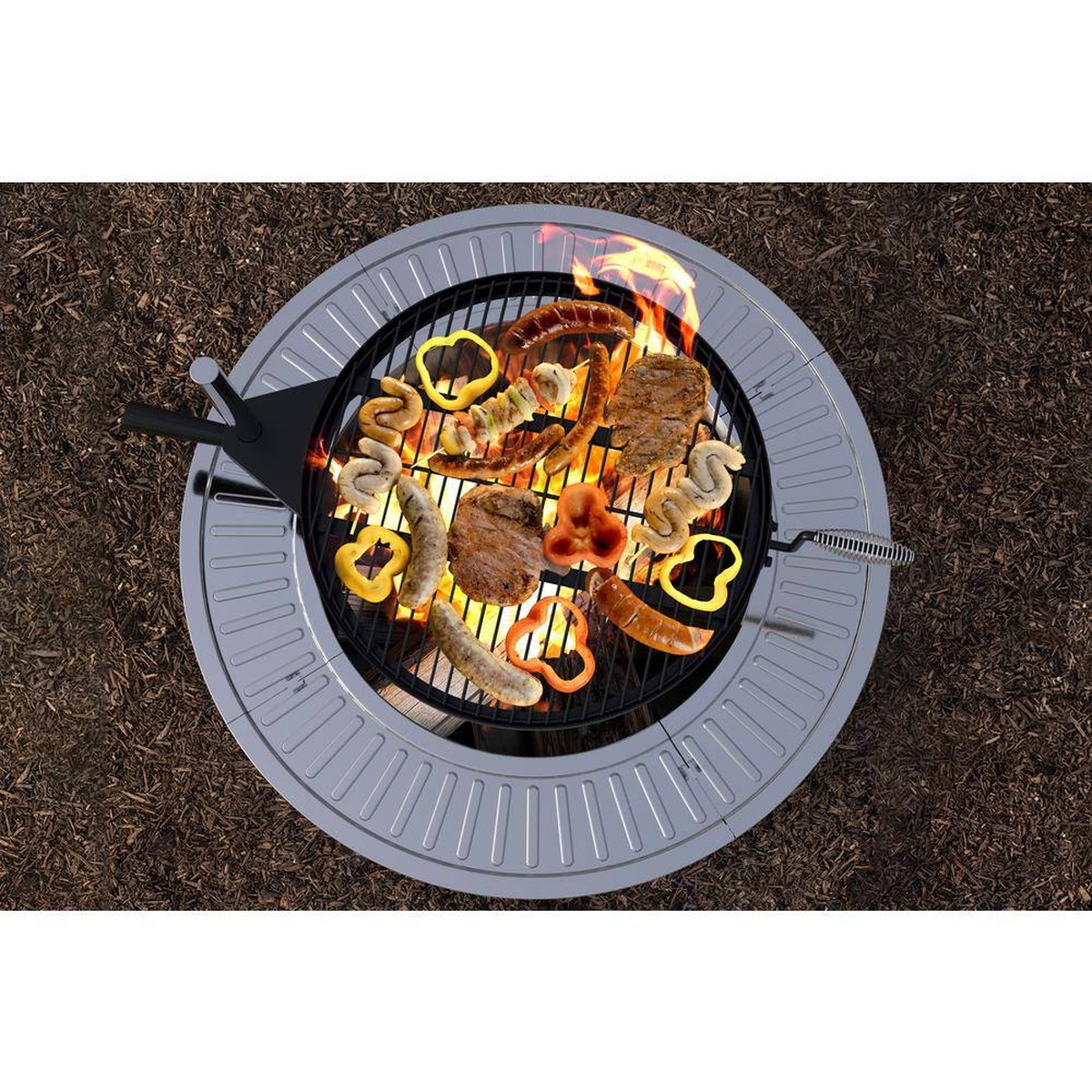 Top view of grate loaded with meats and veggies over active flames
