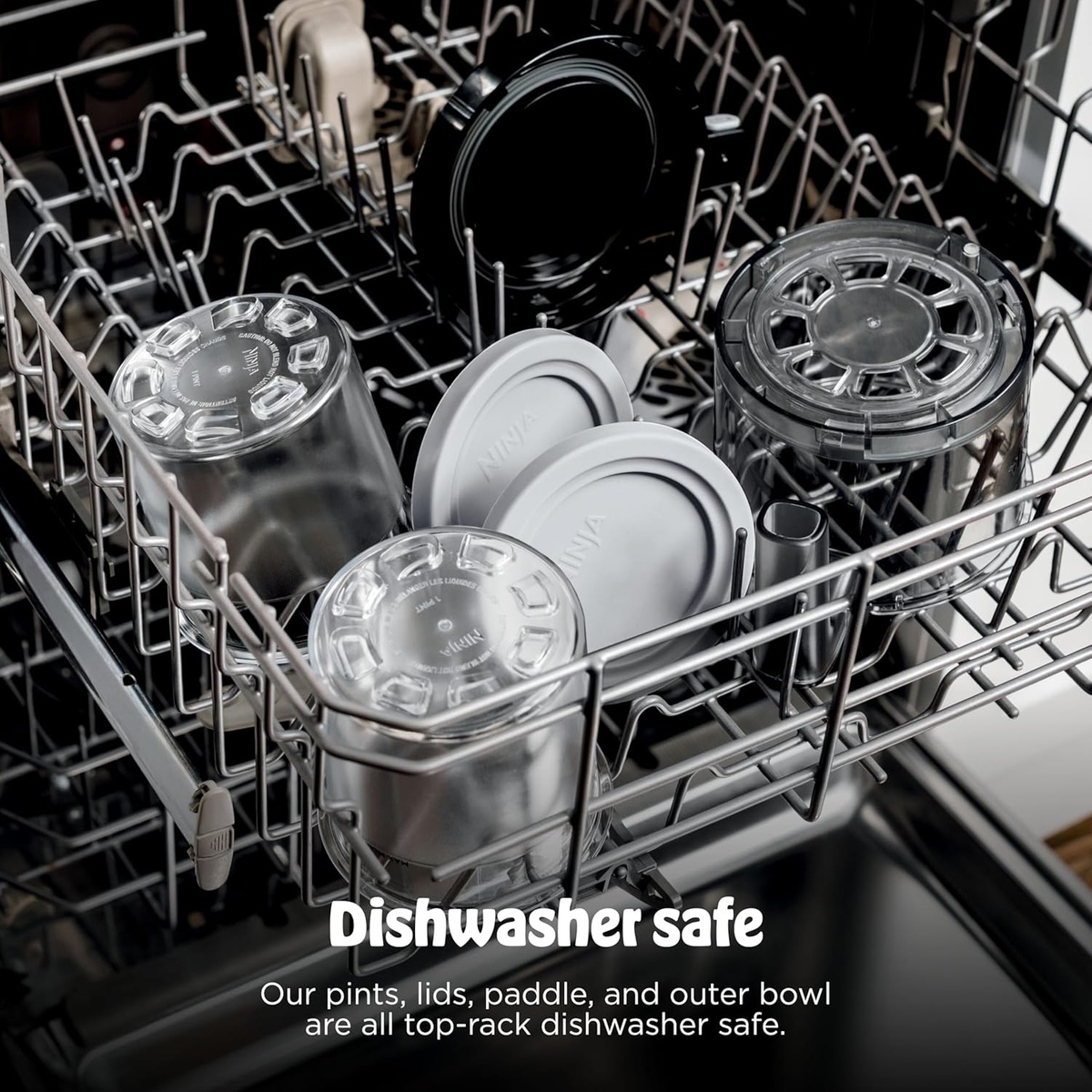 Ninja Creami pints, lids, paddle, and outer bowl loaded on the top rack of a dishwasher