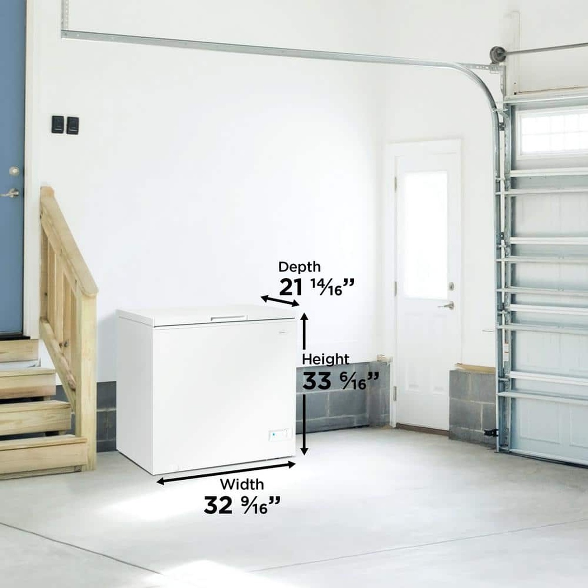 Chest freezer placed in a clean garage setting near a door and stairs.
