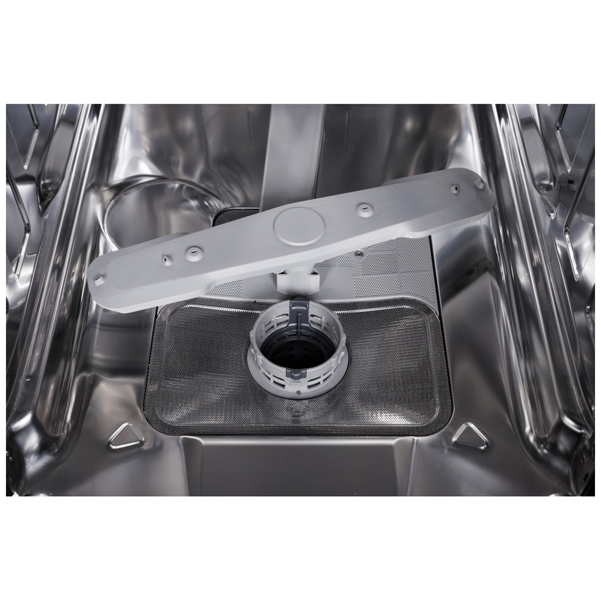 Close-up of stainless tub, lower spray arm and filter system inside the dishwasher