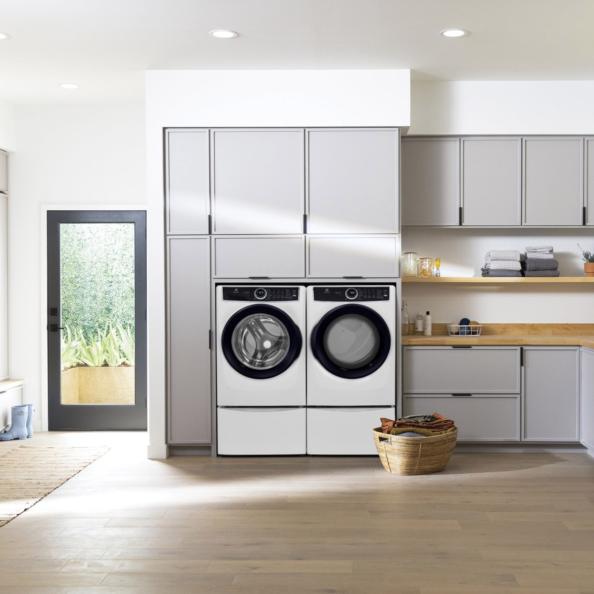 Electrolux front-load washer and dryer shown side-by-side in a bright laundry room