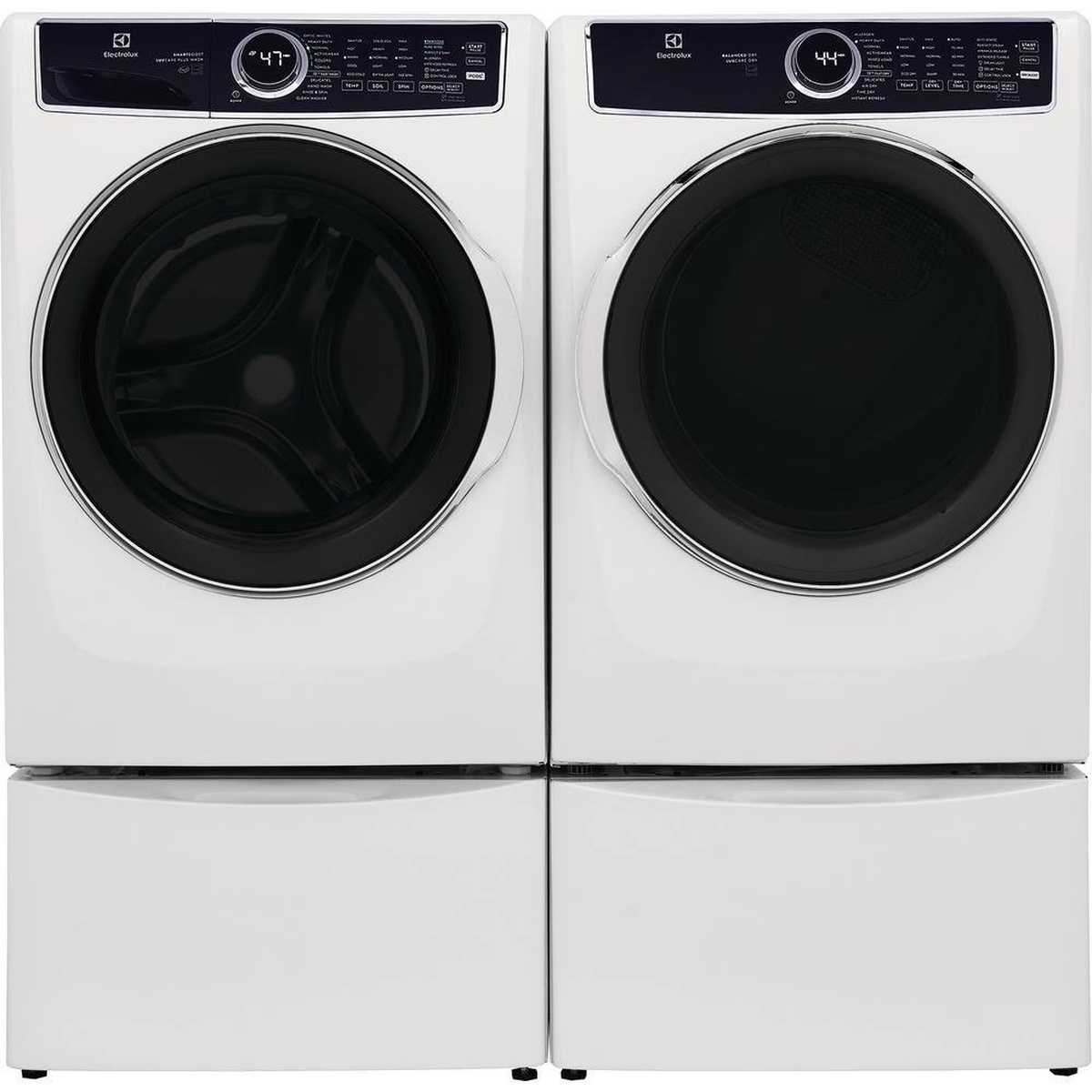 Electrolux front-load washer and dryer installed on matching white pedestals