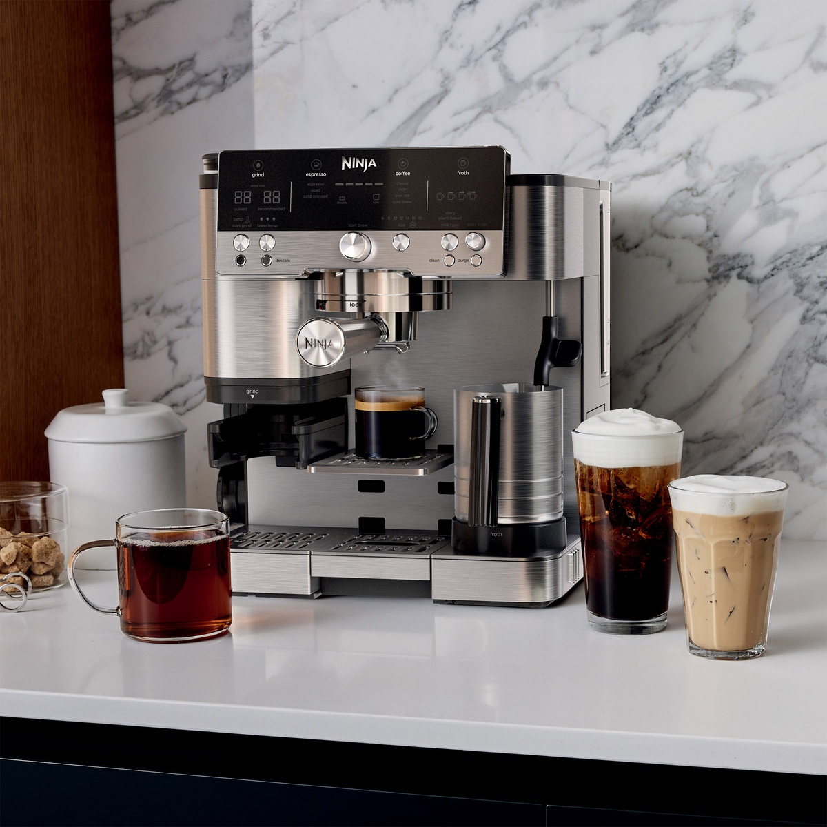 Ninja espresso and drip coffee machine on a counter with espresso, hot coffee, iced coffee, and iced latte drinks.