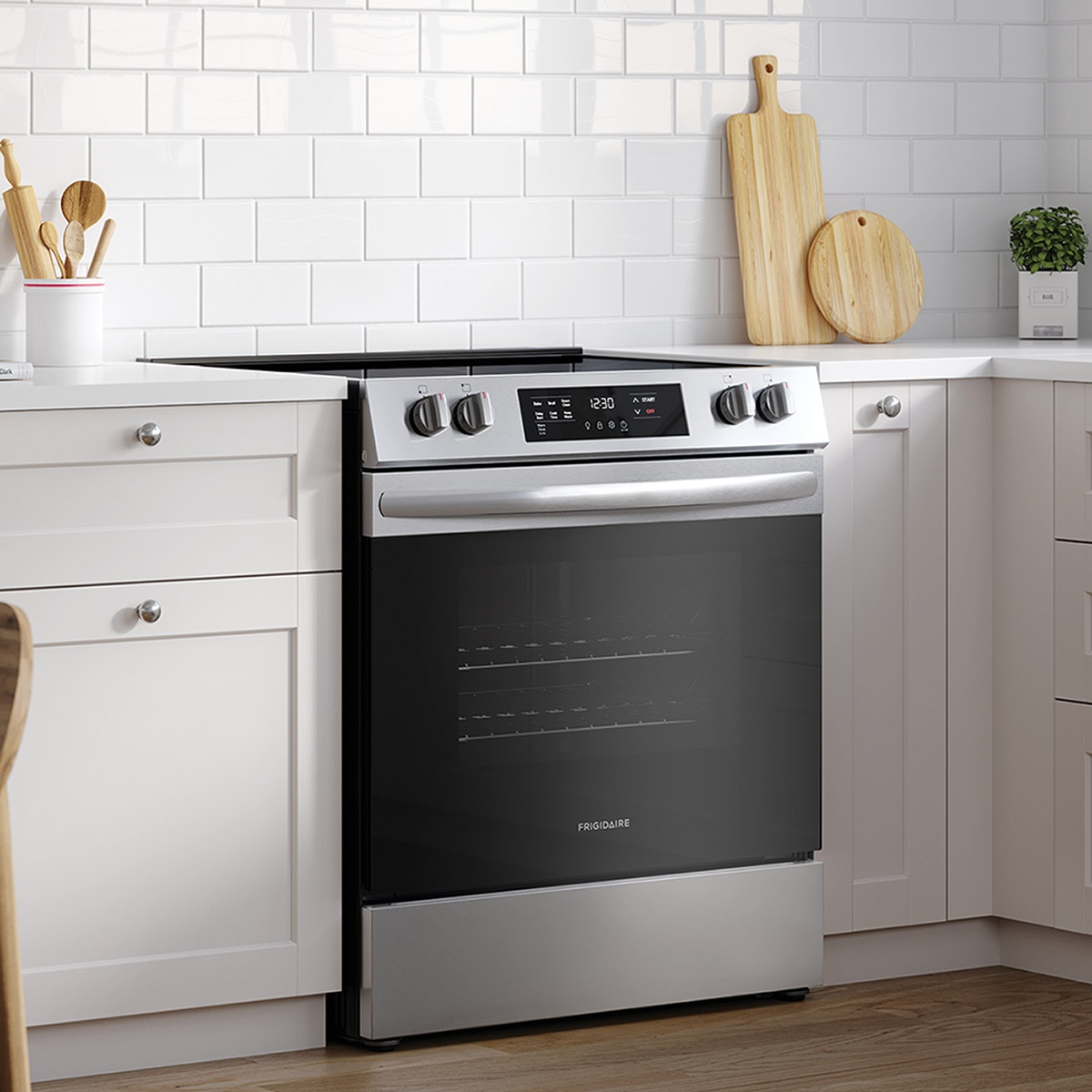 Frigidaire slide-in range installed in a modern white kitchen