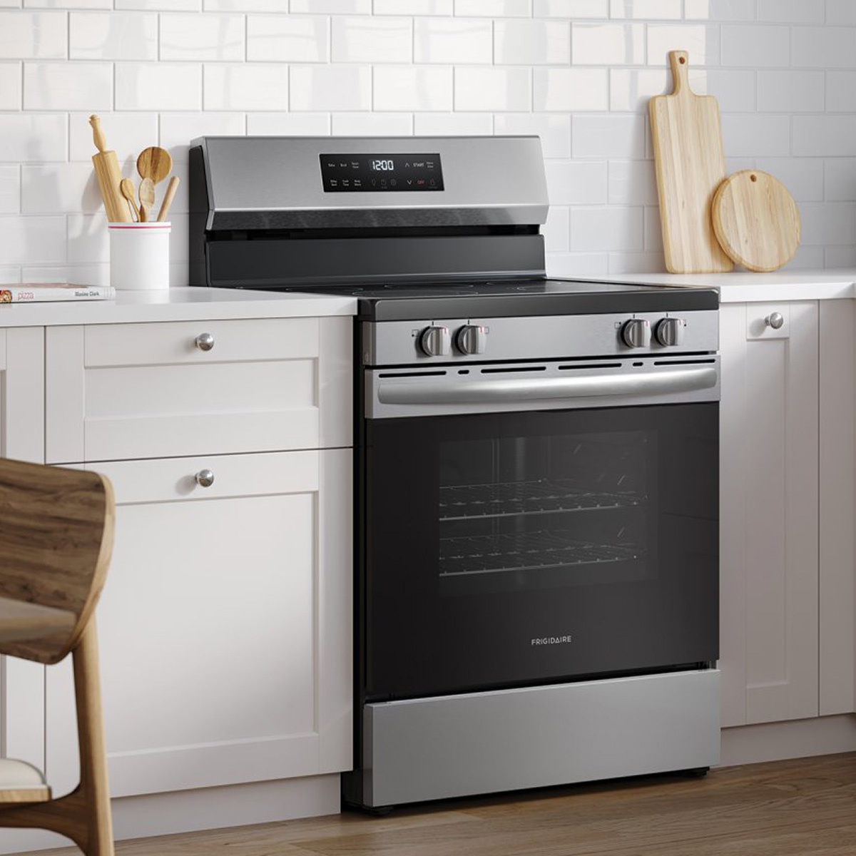 Frigidaire stainless steel electric range installed in a modern white kitchen
