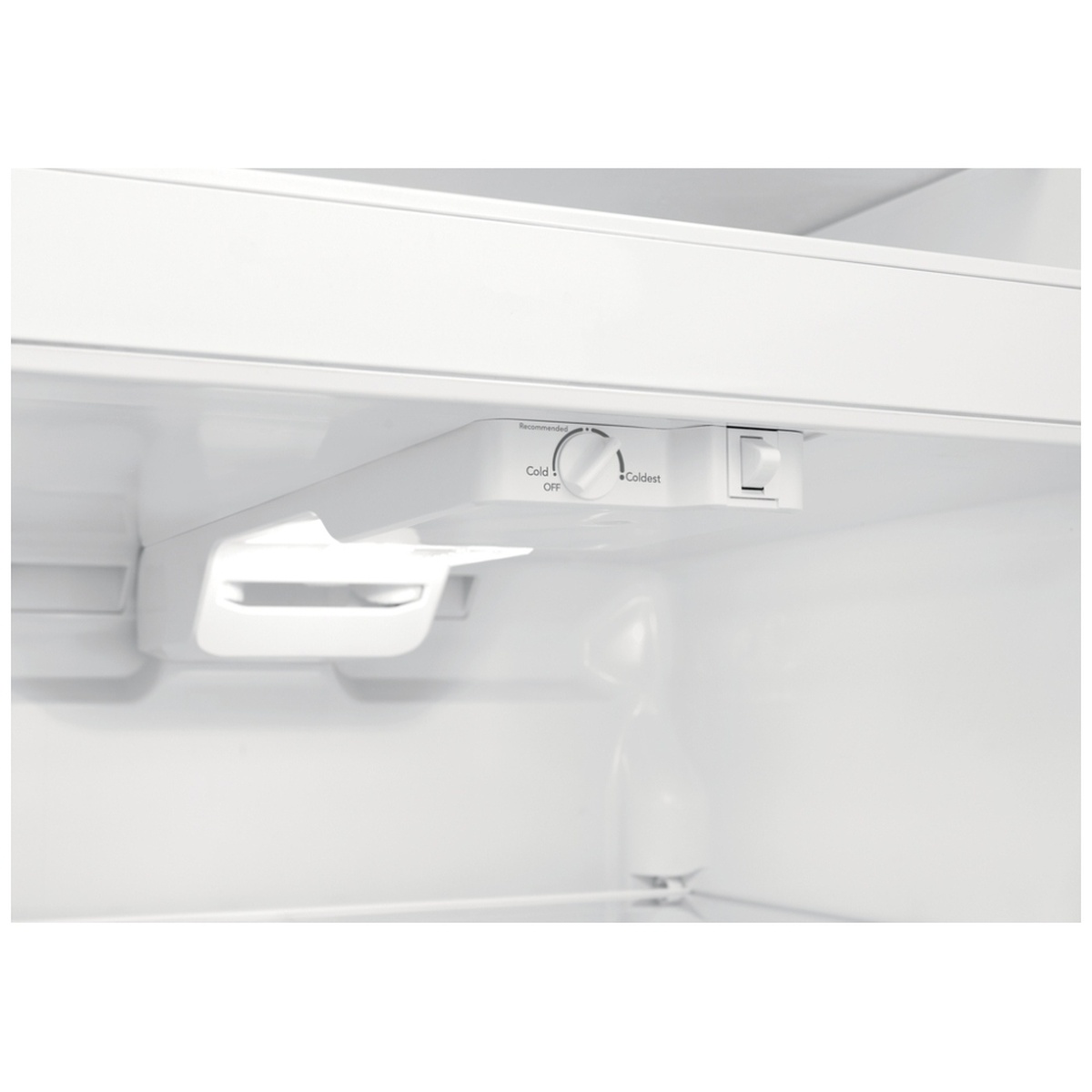 Close-up of single temperature control knob and LED light inside refrigerator