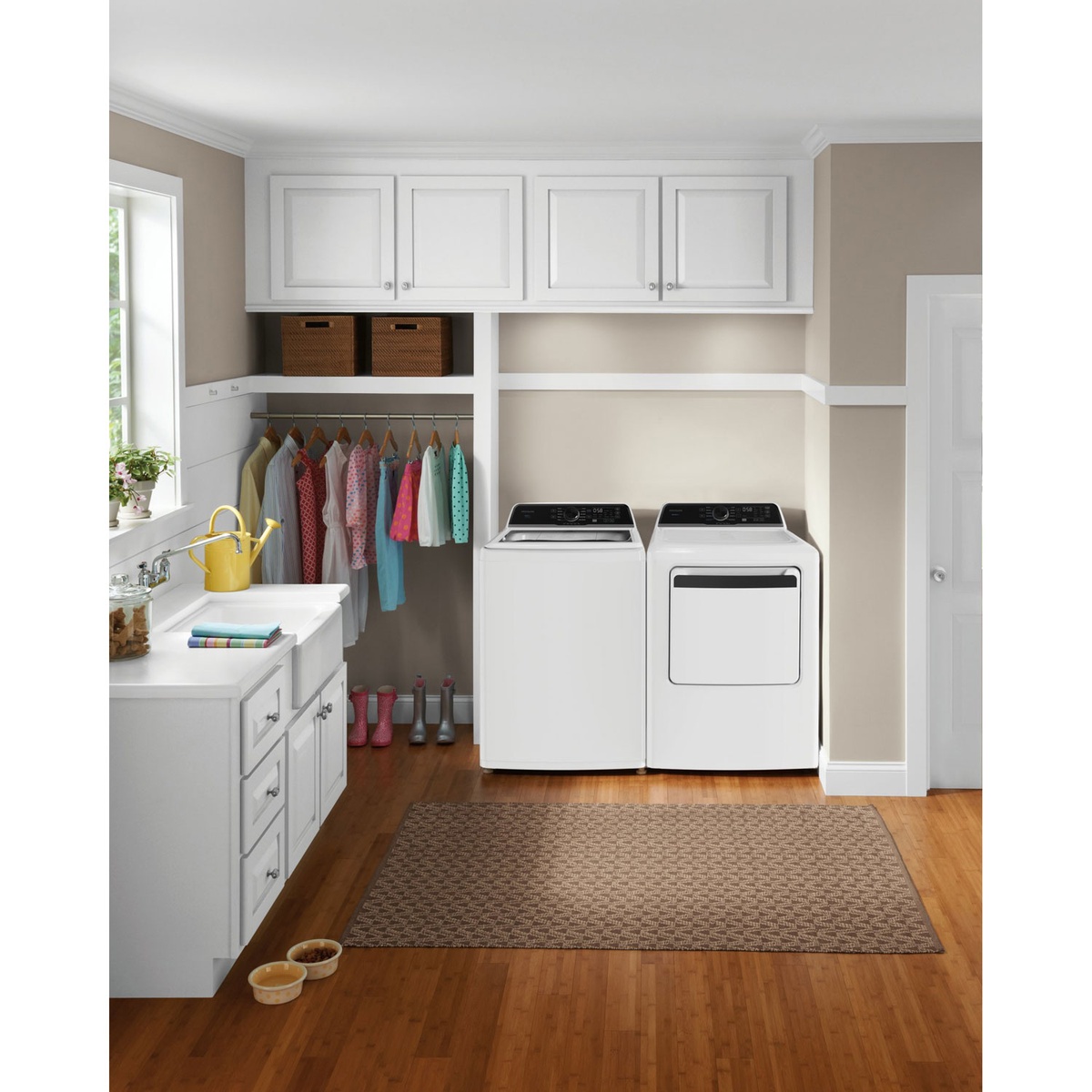 Washer and matching dryer installed in a bright, organized laundry room.