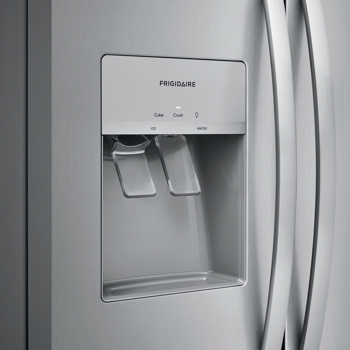 Close-up of exterior ice and water dispenser on stainless steel refrigerator