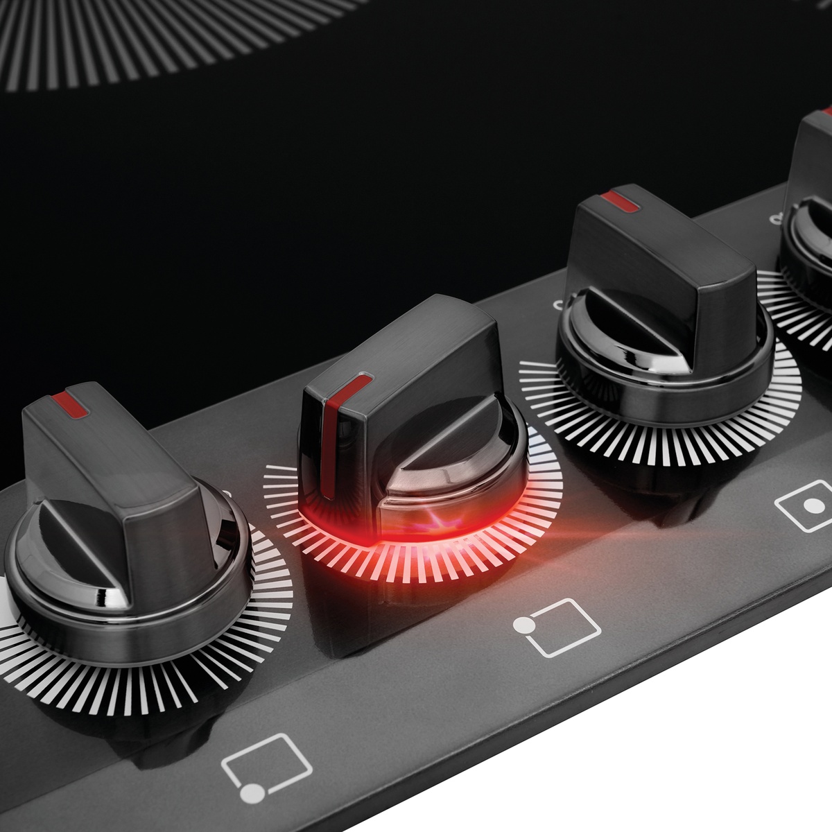 Close-up of backlit control knob illuminated to indicate active burner