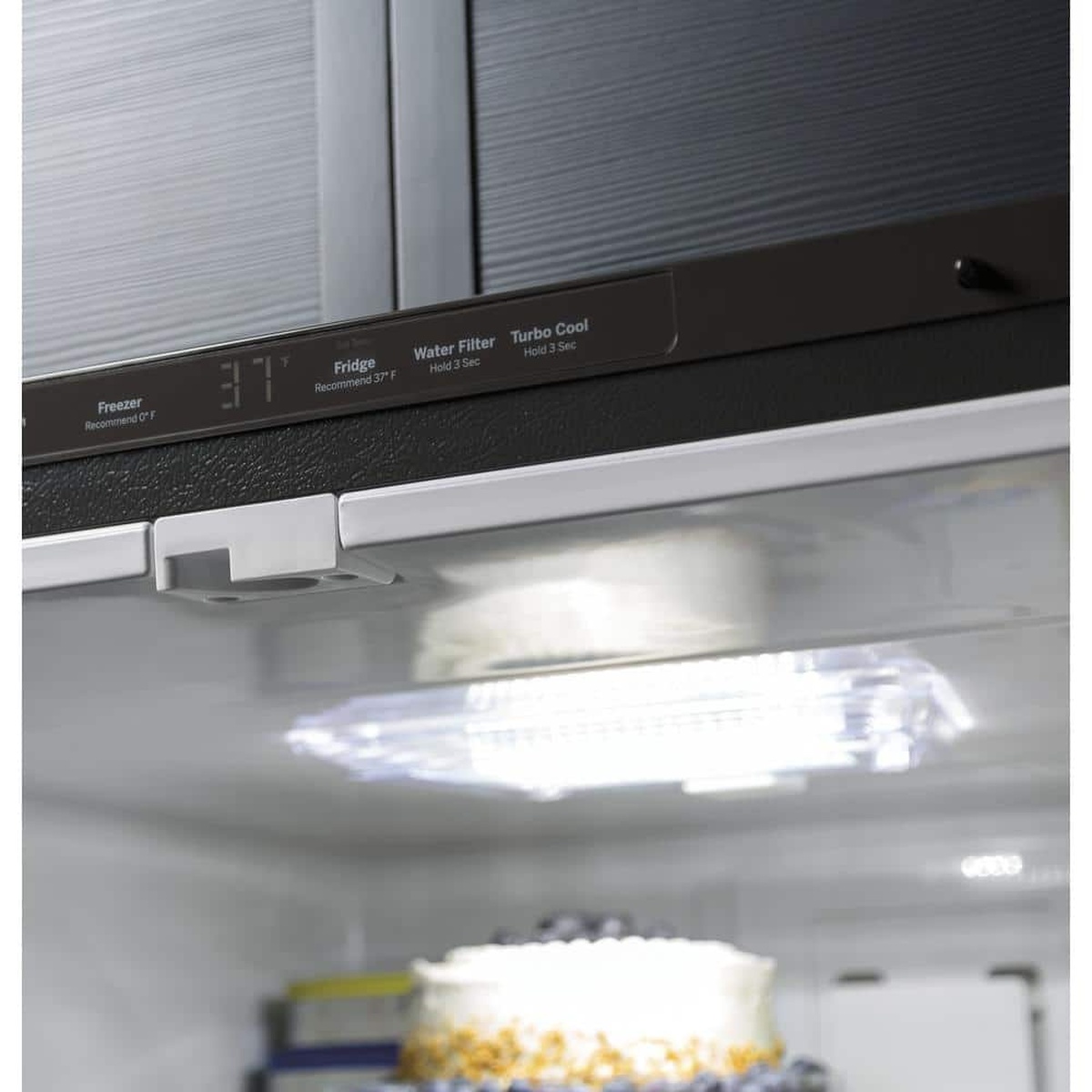 Upfront electronic controls with temperature readout and LED light inside refrigerator.