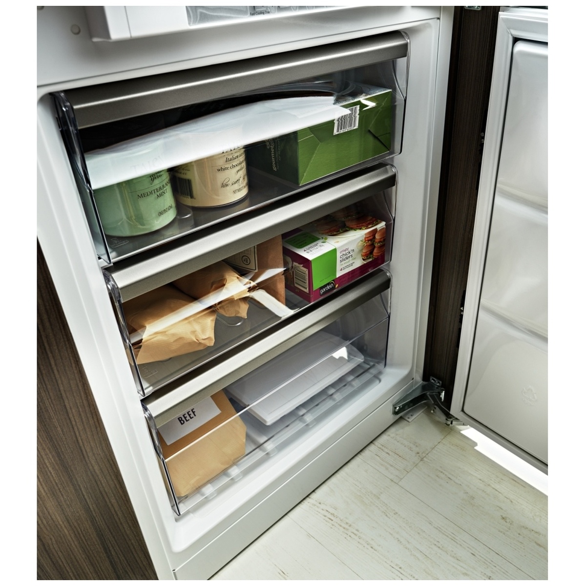 Bottom freezer section with three organized drawers and stored packages