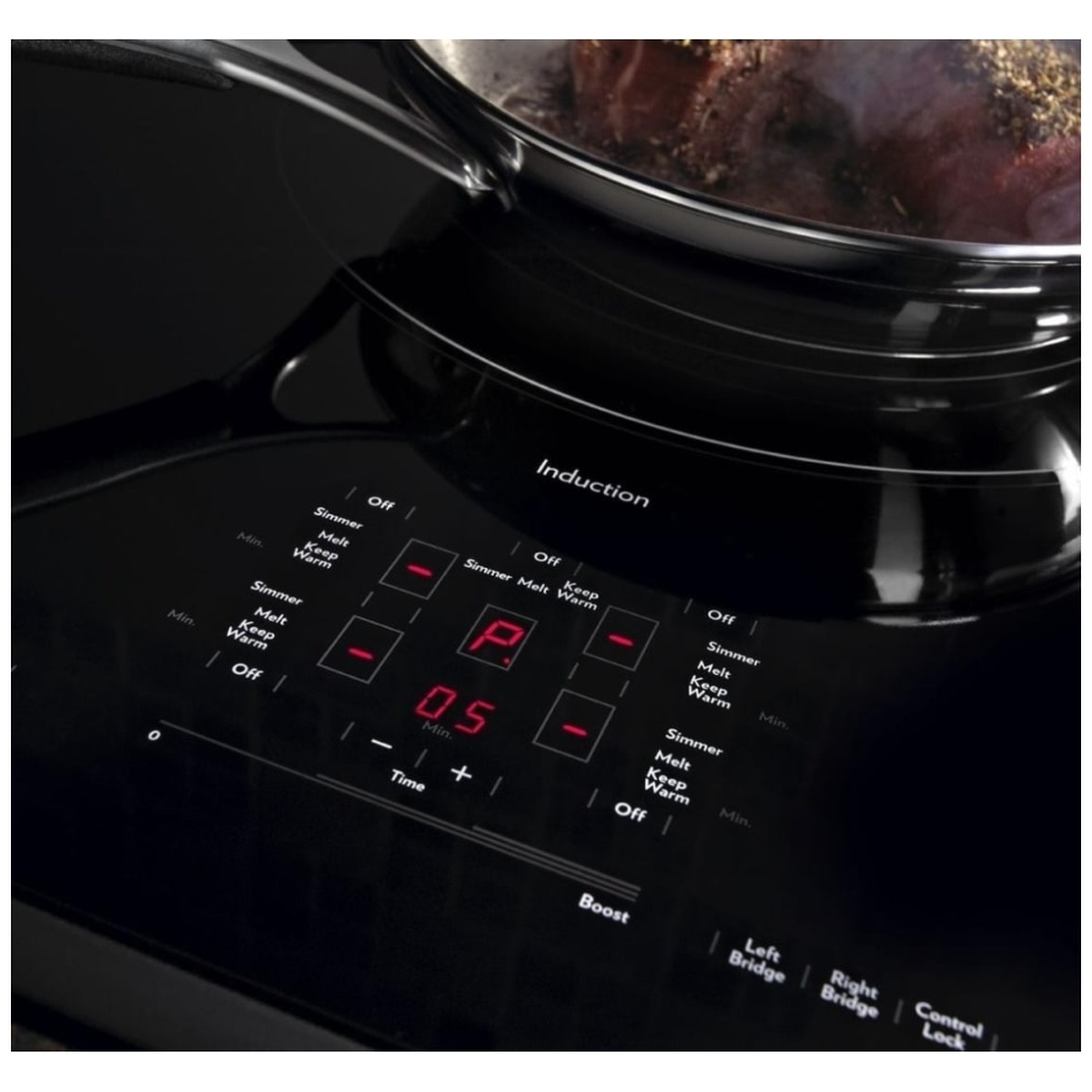 Close-up of cooktop touch controls showing timers, boost, and bridge options with red LED display.