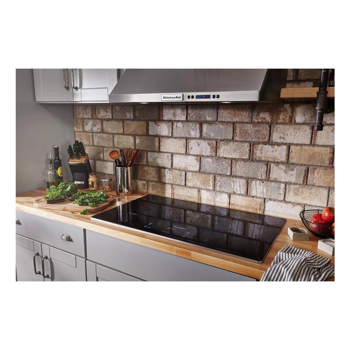 KitchenAid 36-inch electric cooktop installed in a modern kitchen countertop lifestyle scene