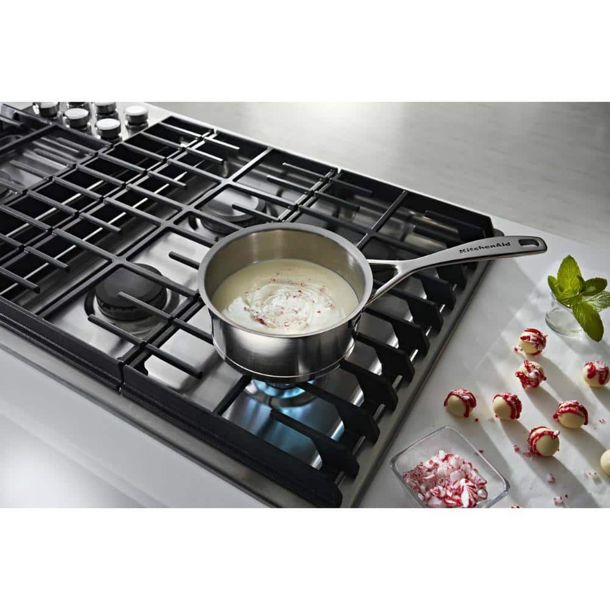Saucepan gently simmering on the cooktop, ideal for melting and delicate sauces.