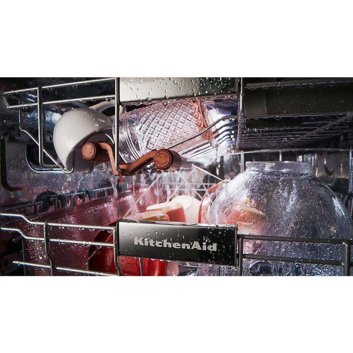 Close-up of targeted wash jets spraying dishes inside the rack