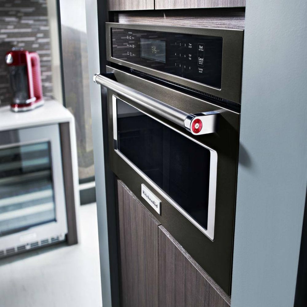 Built-in KitchenAid speed oven installed in a modern cabinet wall.