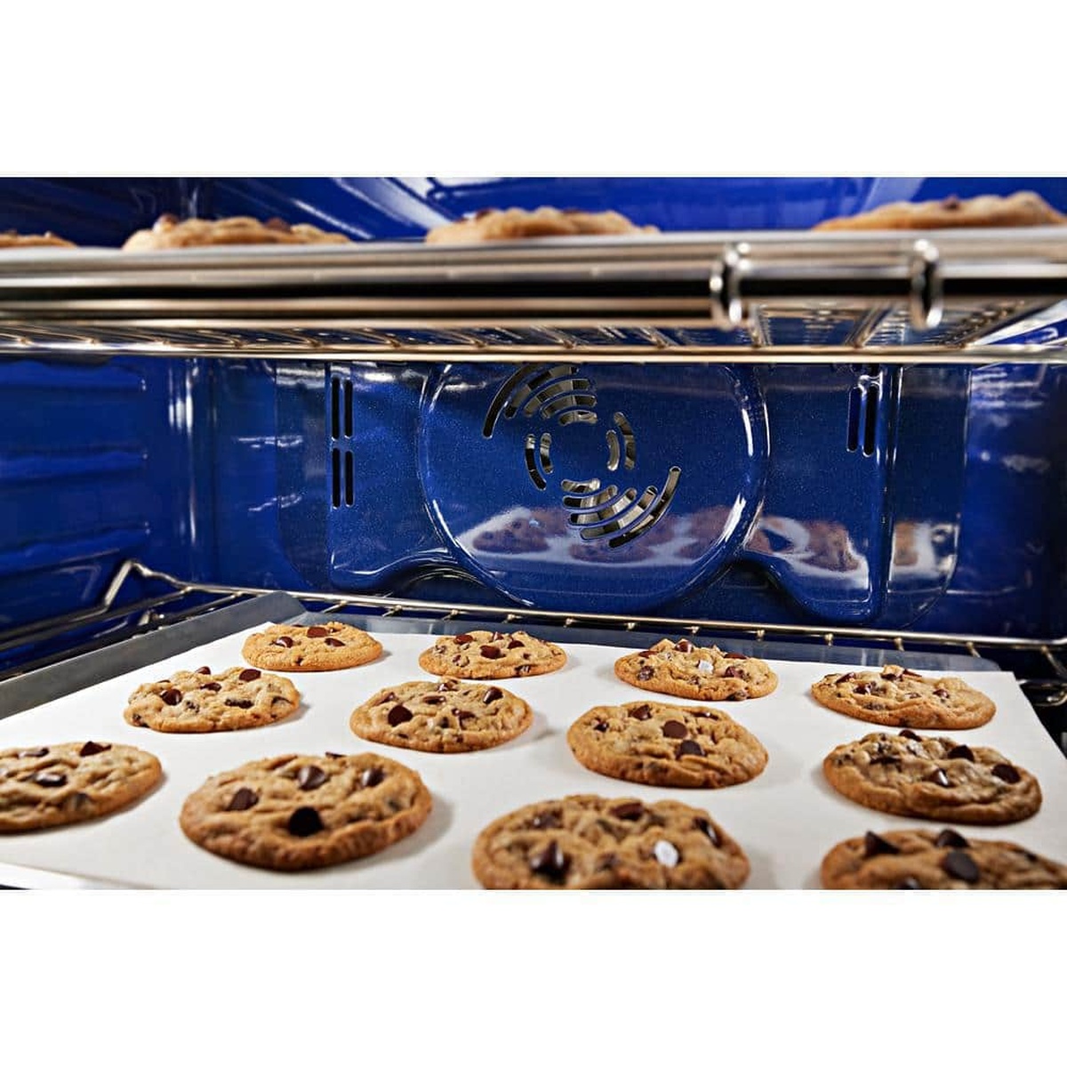 Cookies baking evenly inside the blue-enameled KitchenAid oven cavity with bow-tie convection fan.