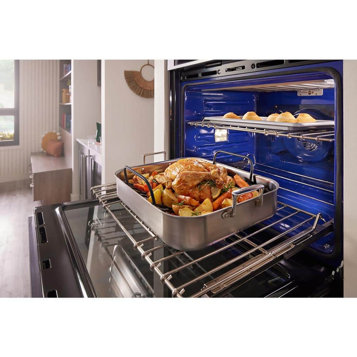 KitchenAid double wall oven with roll-out rack extended for easy loading of a roasting pan.