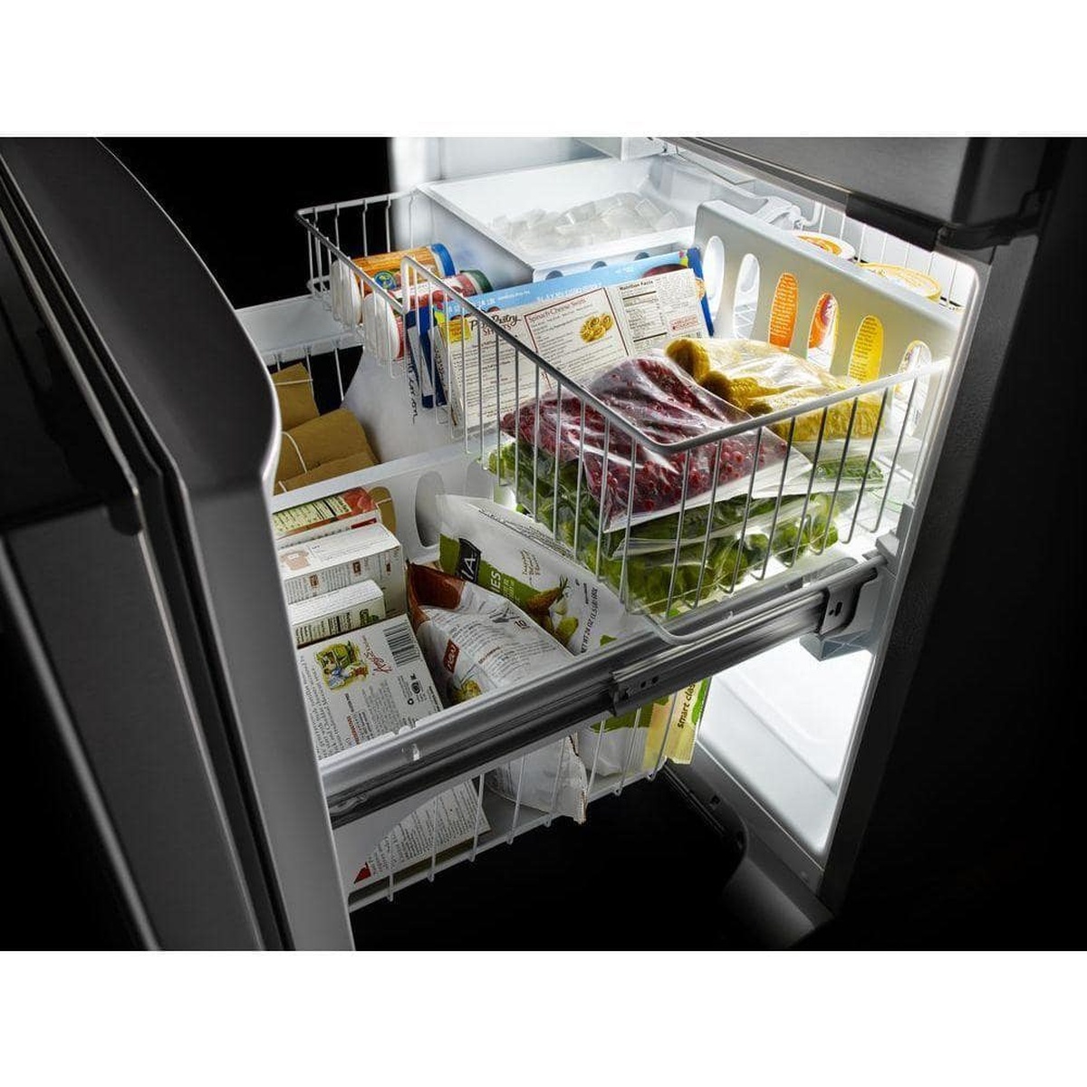 Freezer drawer with sliding wire baskets and built-in ice bin organized with groceries.