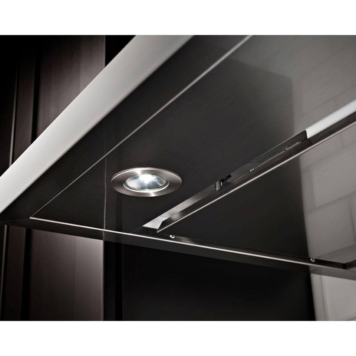 Underside view of the range hood showing bright round LED task light and perimeter intake panel.