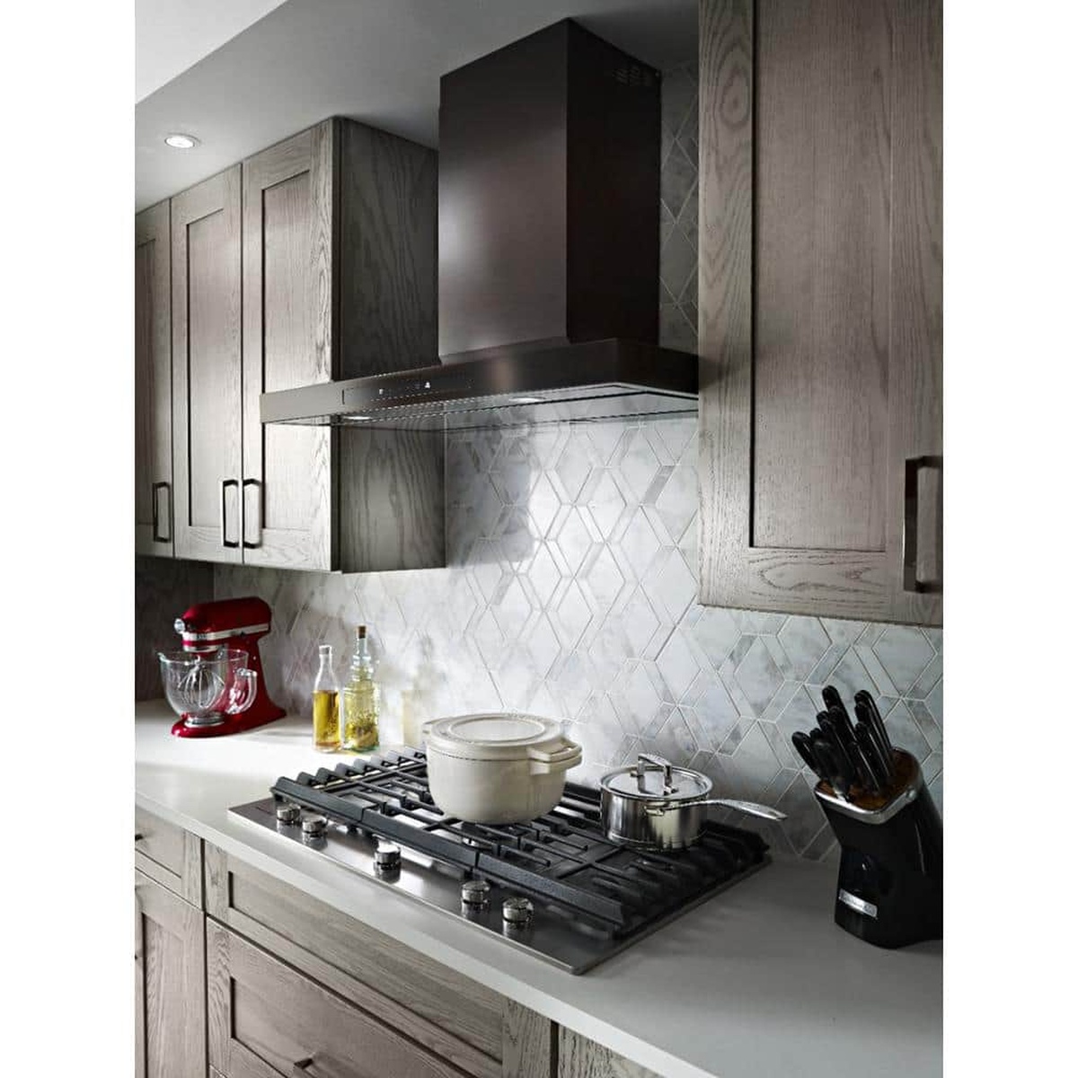 Lifestyle kitchen showing the hood illuminating the cooktop and backsplash.