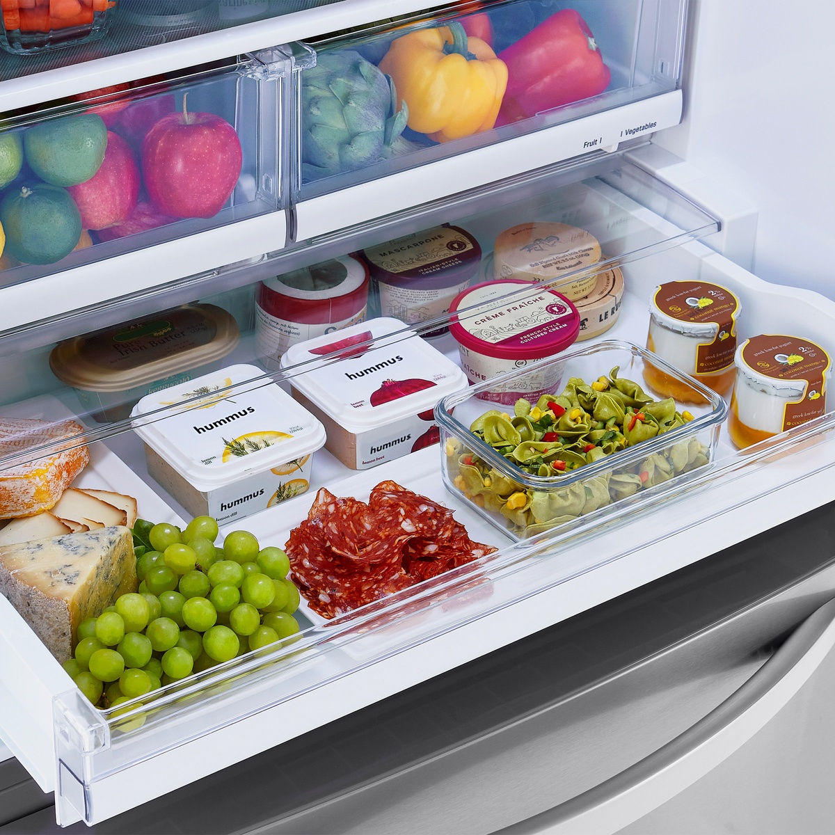 Full-width pantry drawer and produce crispers stocked with food