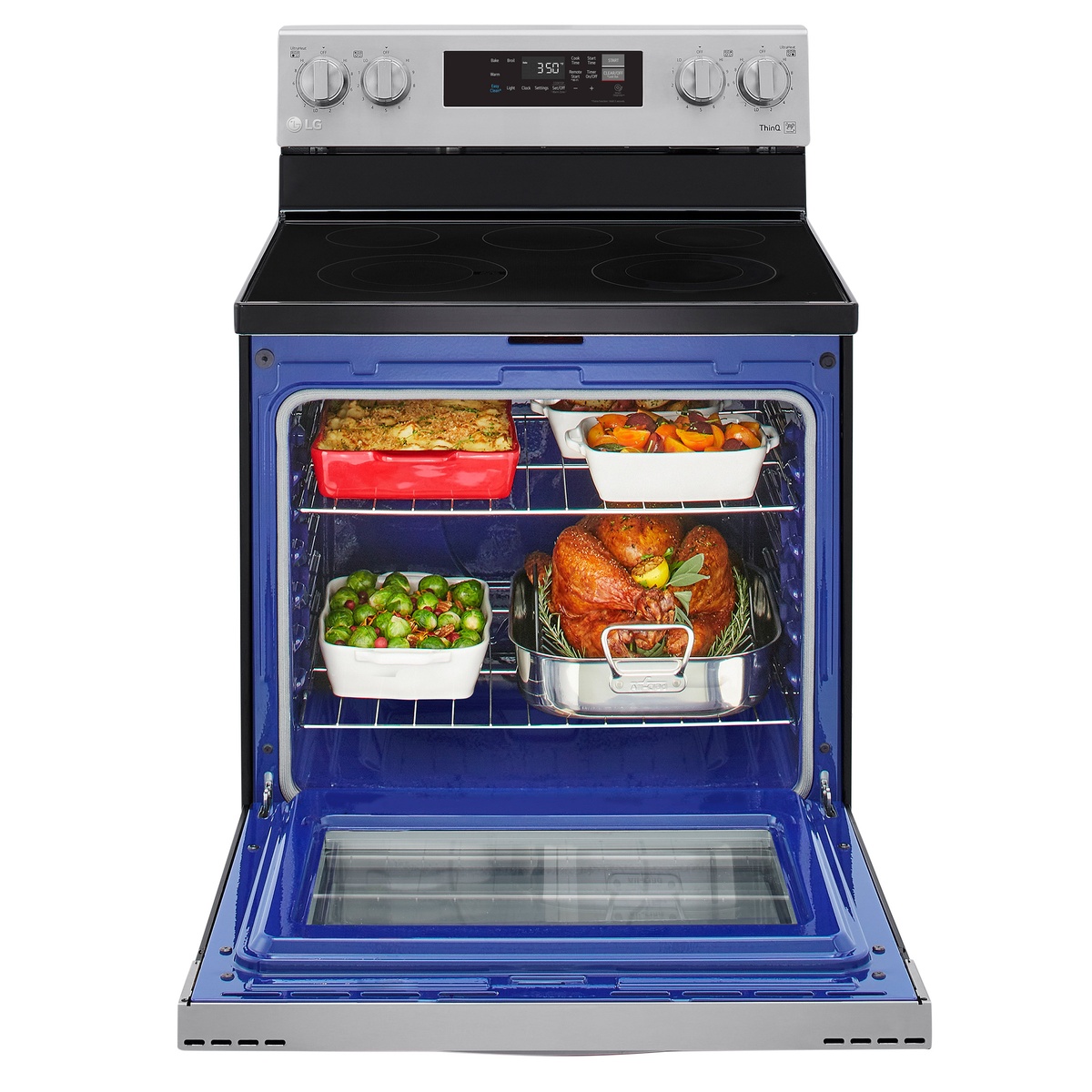 Large LG oven cavity loaded with multiple dishes on two racks