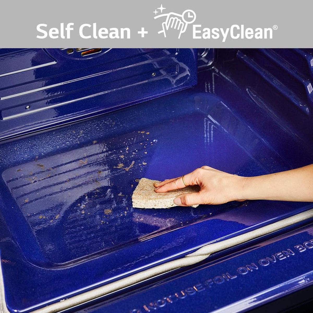 Hand wiping blue oven interior with Self Clean + EasyClean callout