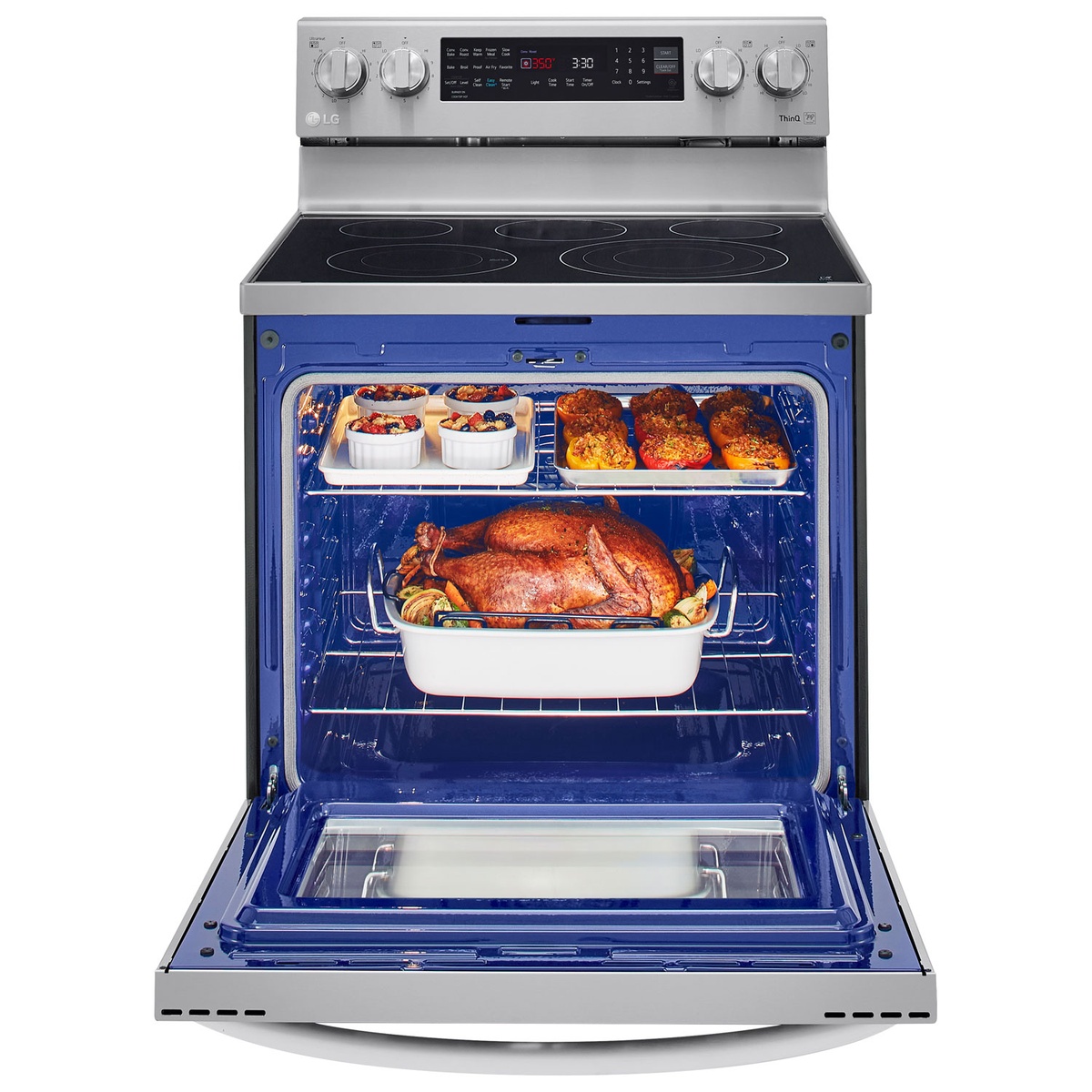 Open LG oven showing spacious blue interior filled with multiple dishes on two racks
