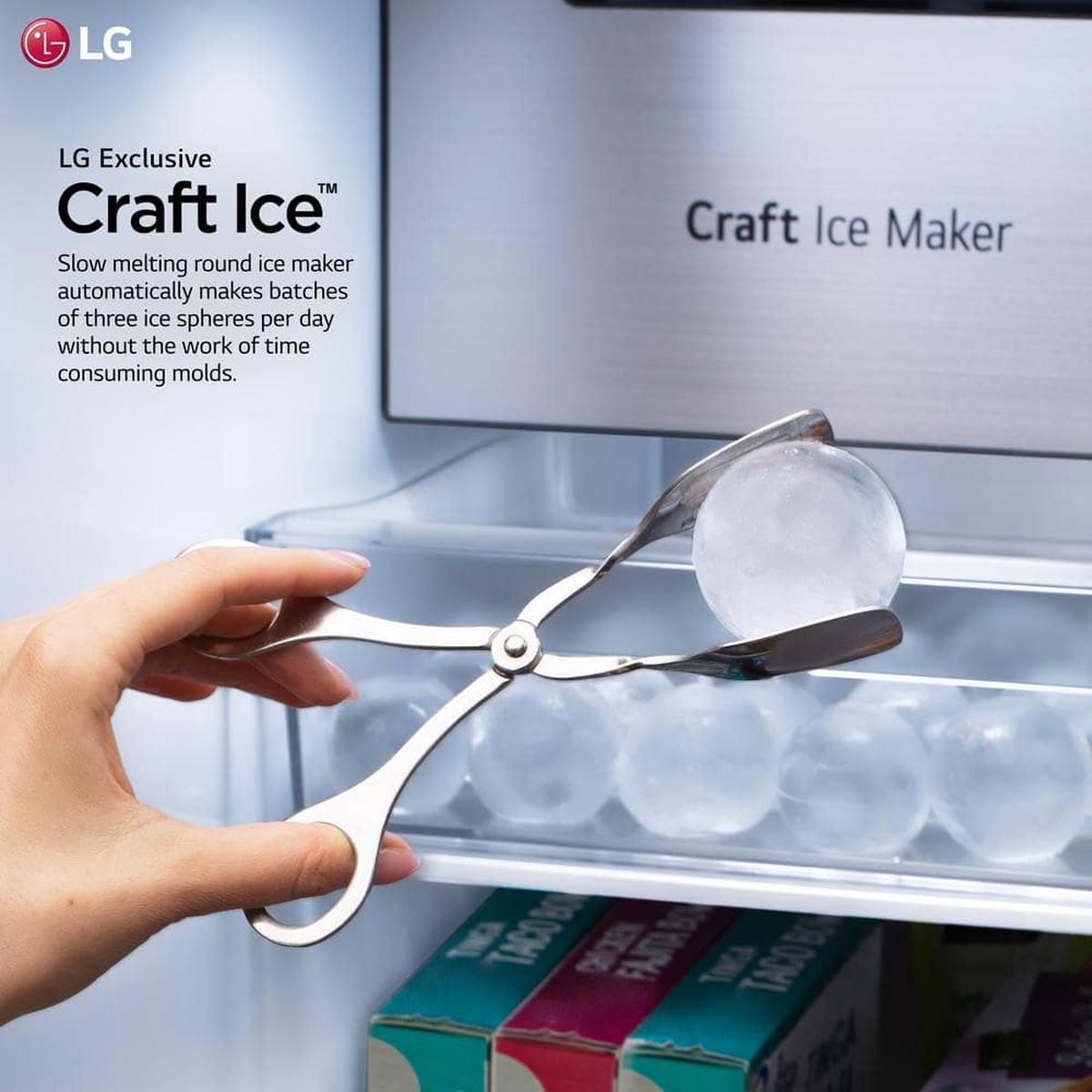 Close‑up of LG Craft Ice Maker with a hand holding a round ice sphere.