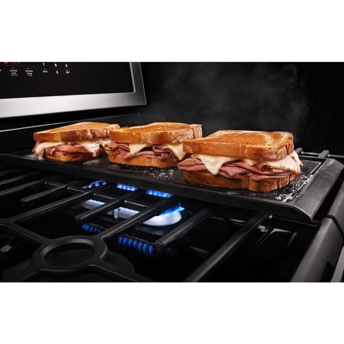 Griddle on center oval burner toasting sandwiches evenly