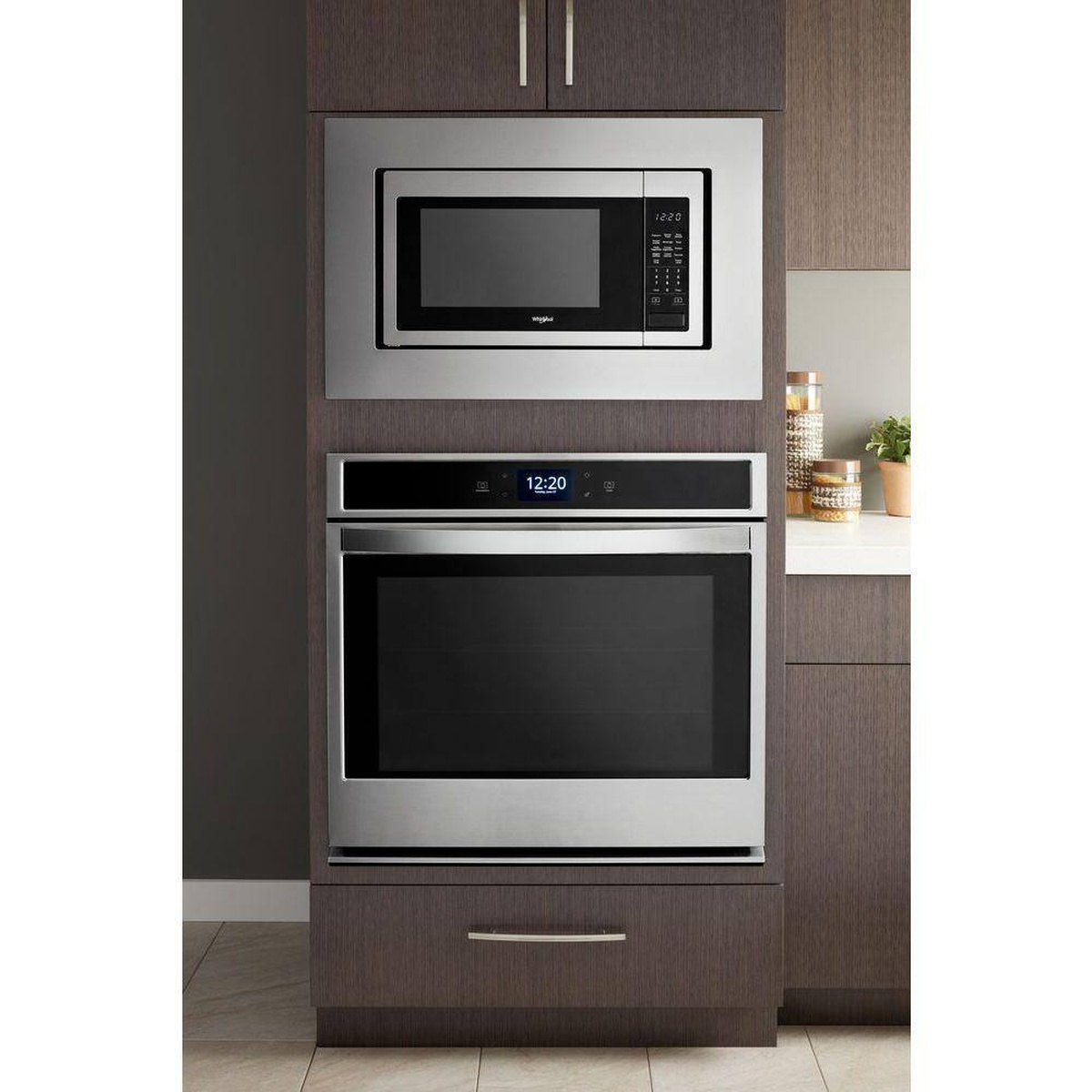 Installed microwave trim kit above a wall oven showing integrated cabinetry