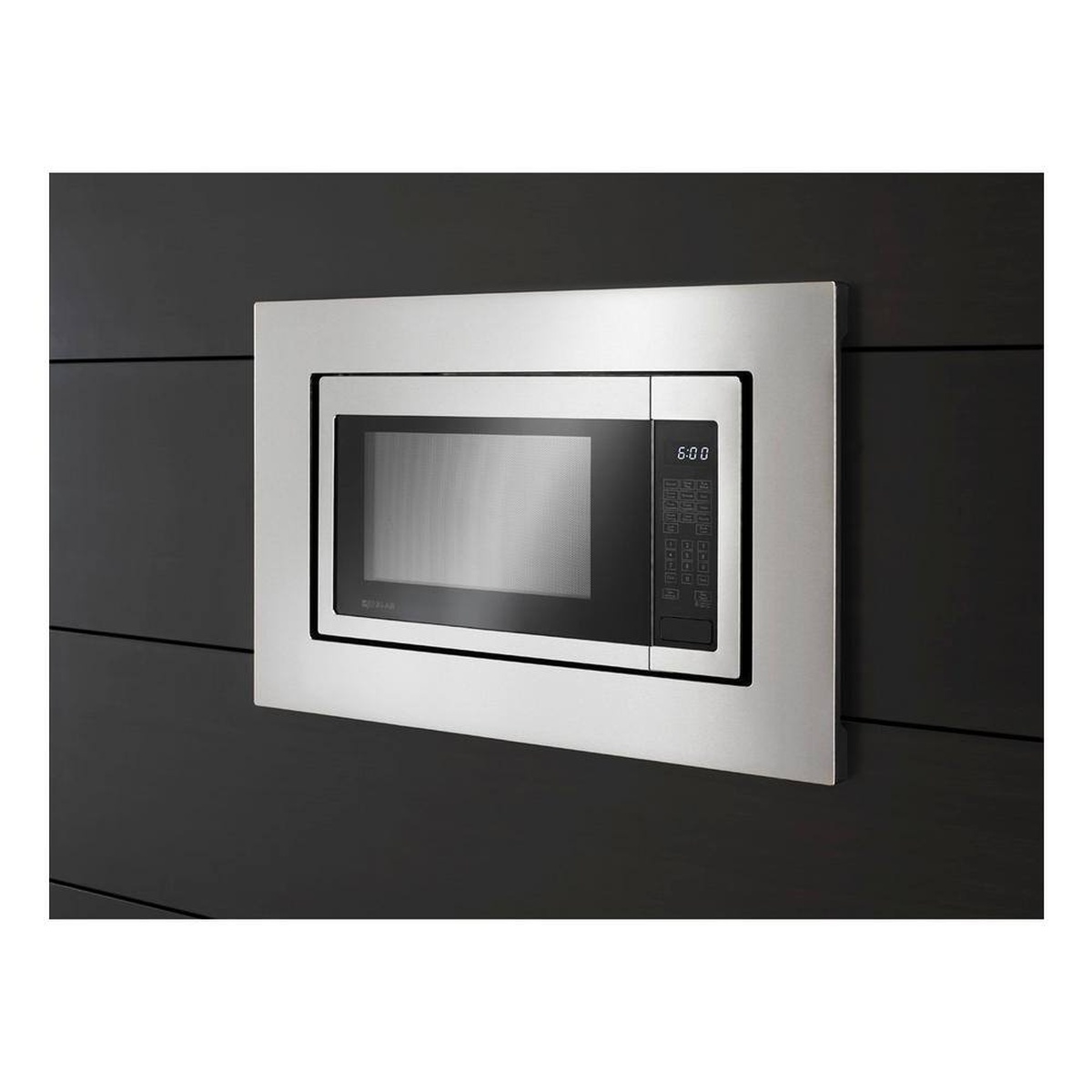 Trim kit framing a microwave for a clean built-in look on a dark cabinet wall