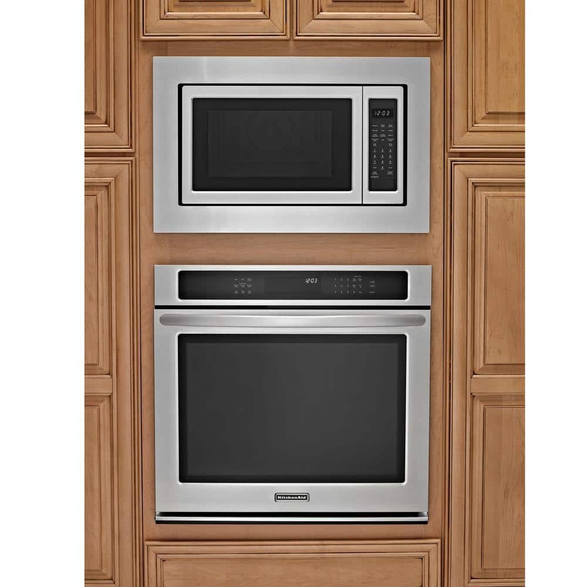 Microwave installed above wall oven using stainless trim kit, flush with cabinetry