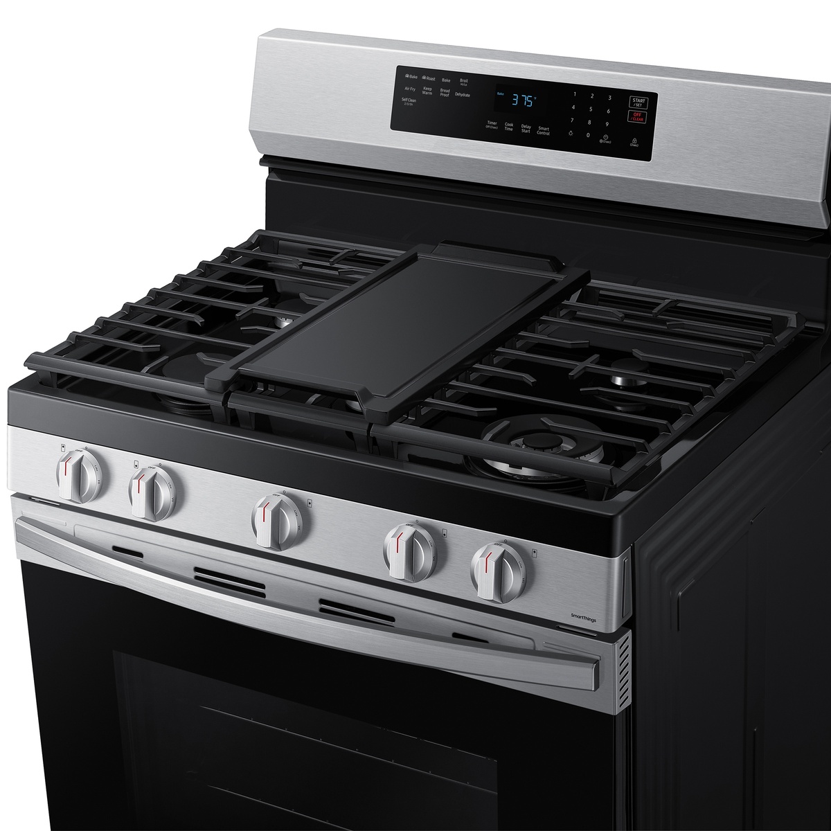 Five-burner gas cooktop with center griddle and edge-to-edge grates.