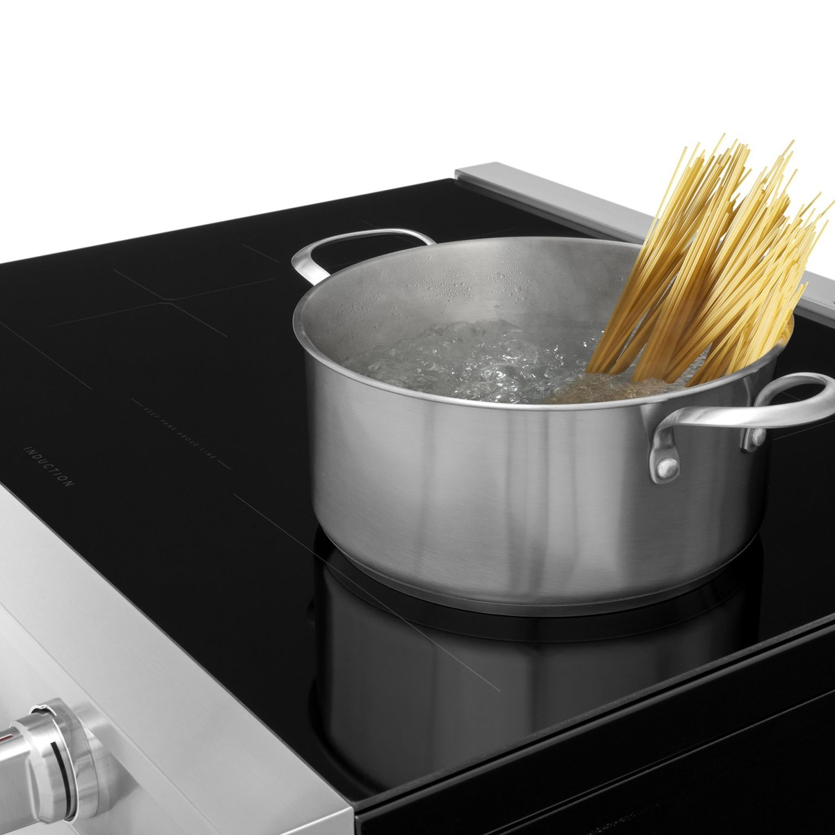 Induction cooktop rapidly boiling pasta water in stainless pot
