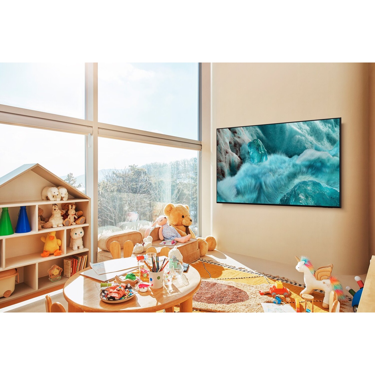 Samsung QLED TV wall-mounted in a bright playroom setting