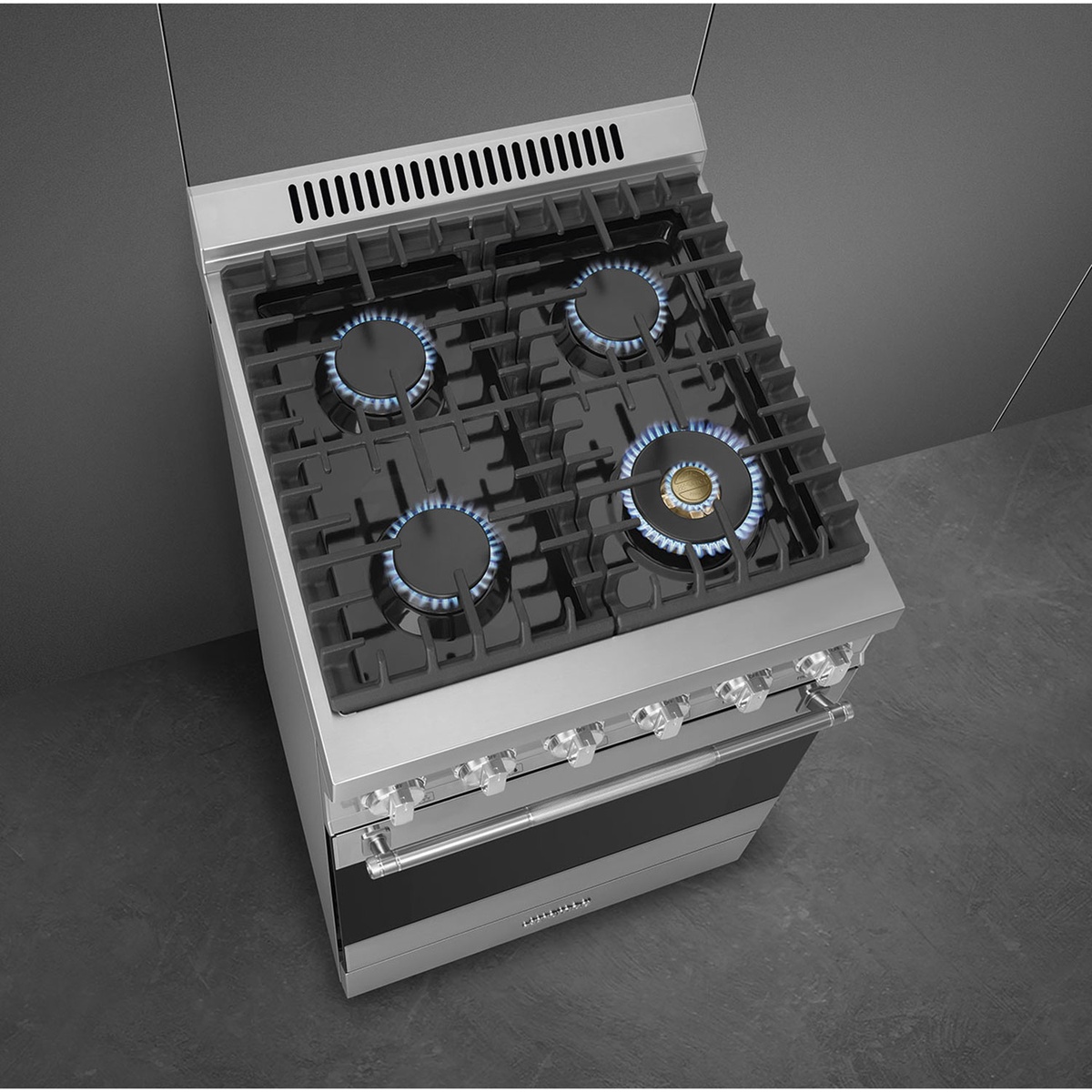 Top-down view of the SPR24UGGX cooktop with four burners lit, including a brass power burner