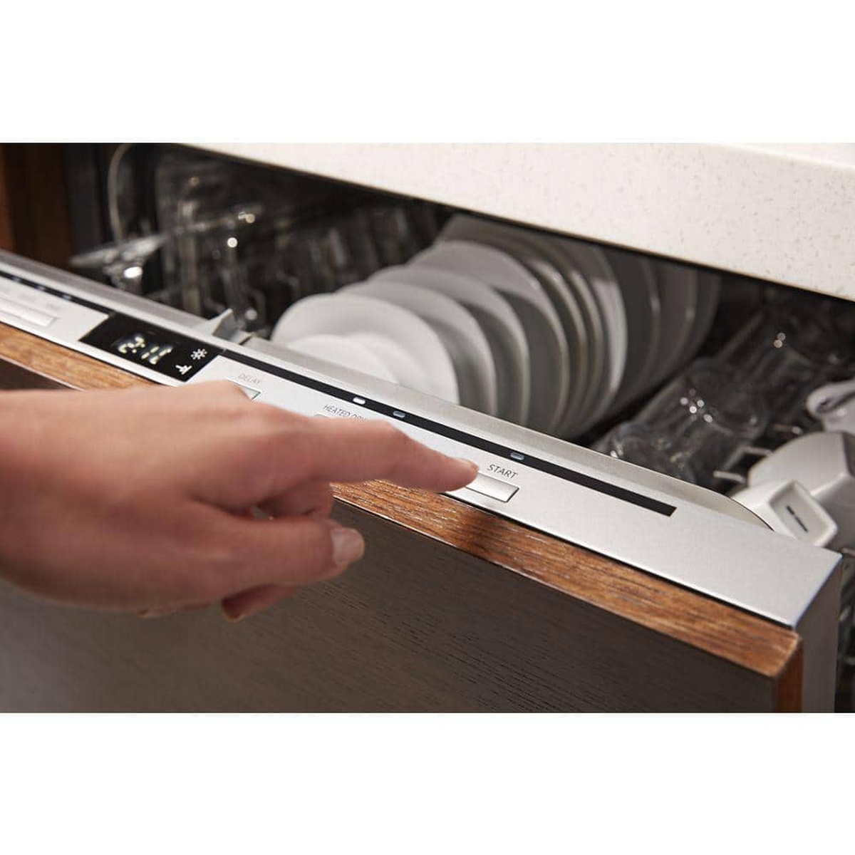 User pressing the Start button on the dishwasher's hidden control panel.