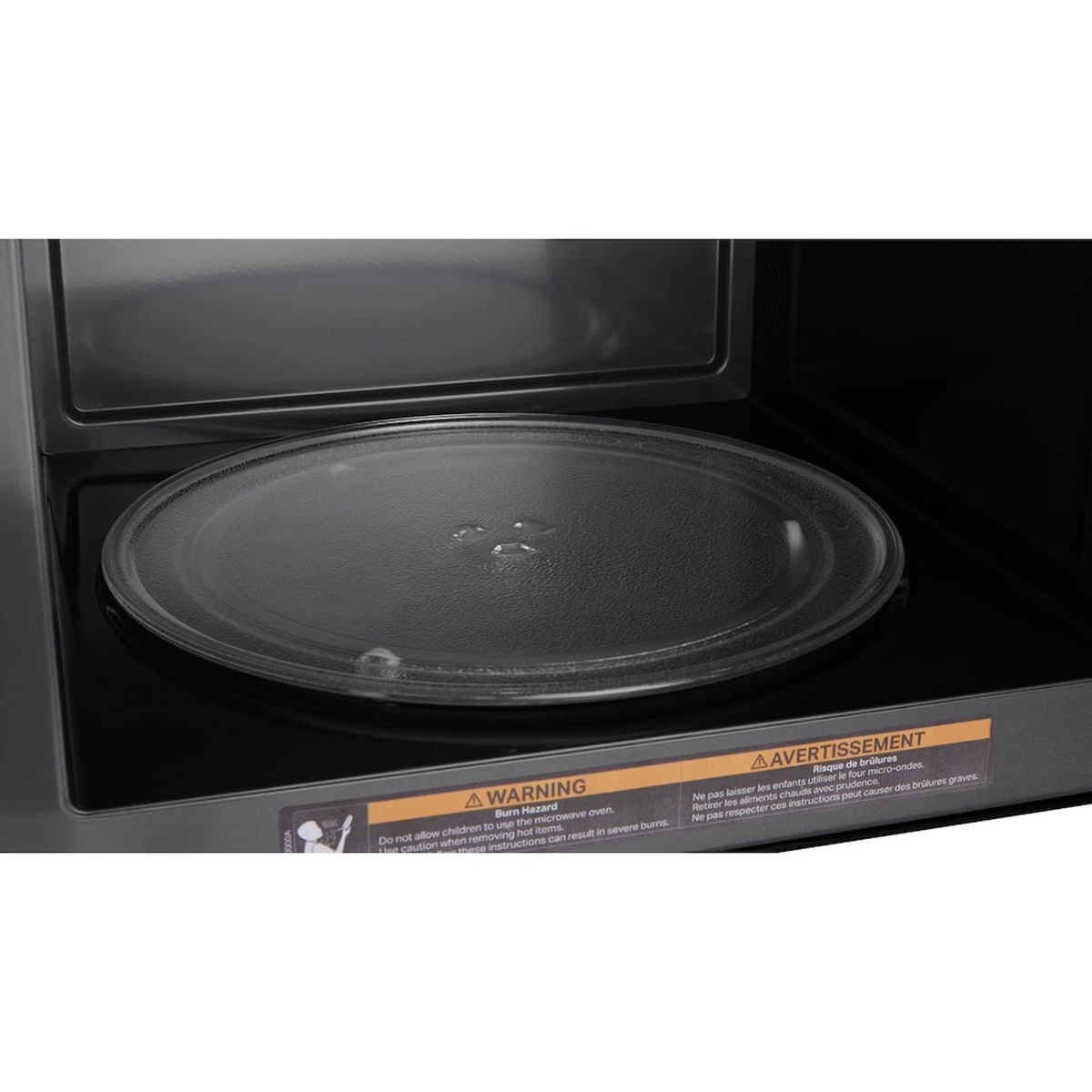 Close-up of the round glass turntable inside the microwave cavity.
