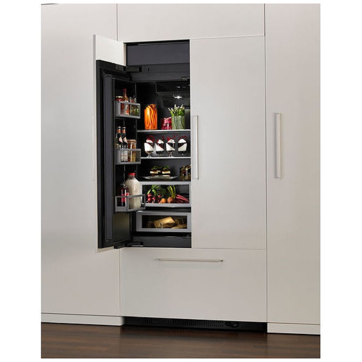 Built-in refrigerator with matching white panels; door open showing interior storage.